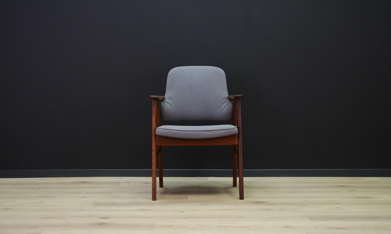 A unique armchair from the 1960s-1970s - Scandinavian design. A beautiful Minimalist form with sensational armrests. Teak construction covered with a new fabric (color - gray). Preserved in good condition (small dings and scratches on wooden