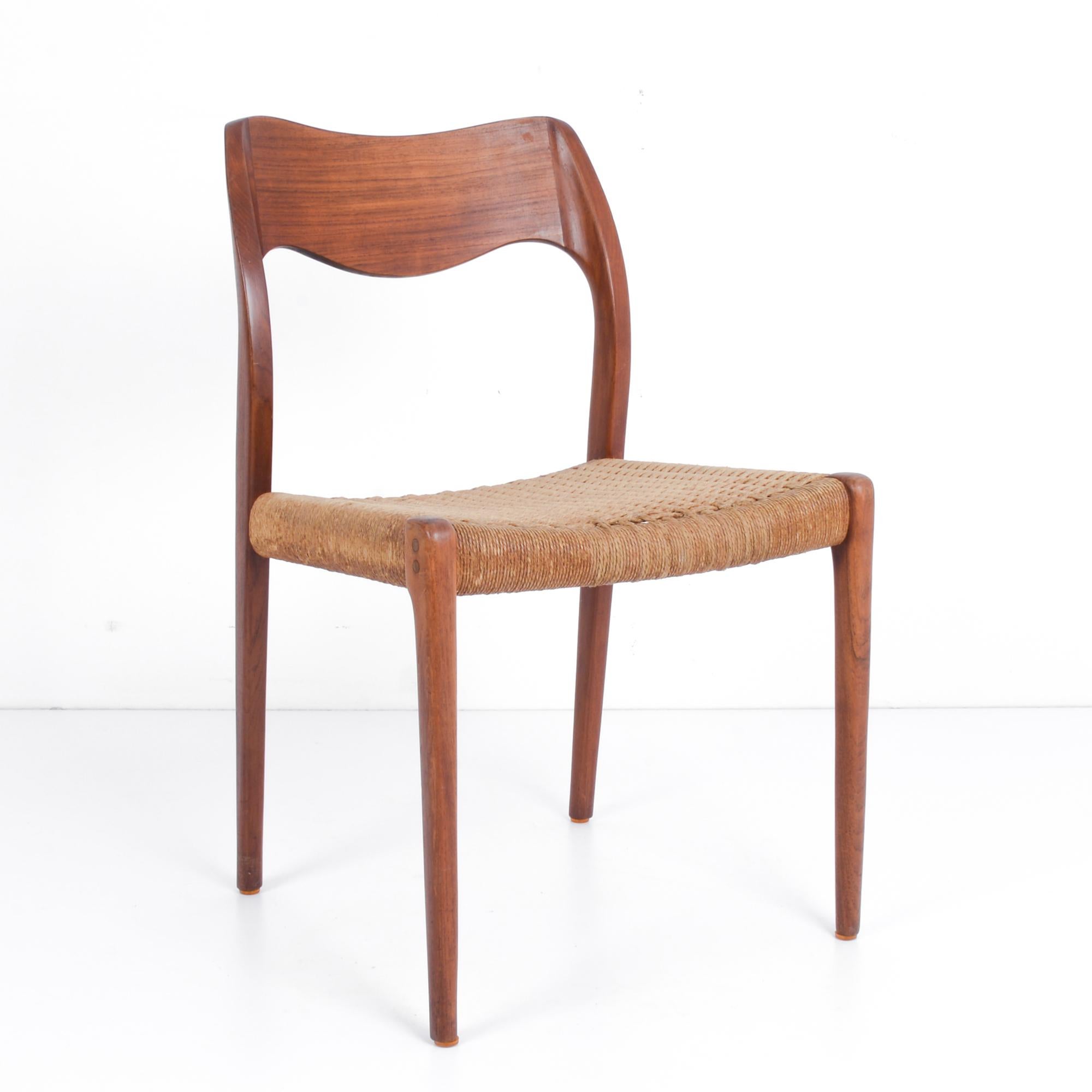 This captain’s chair designed by Arne Hovmand-Olsen was made in Denmark, circa 1960. The curved back and tapered legs of this elegant chair show off the beautiful patina of the teak. A woven seat knotted to the frame is in excellent condition and