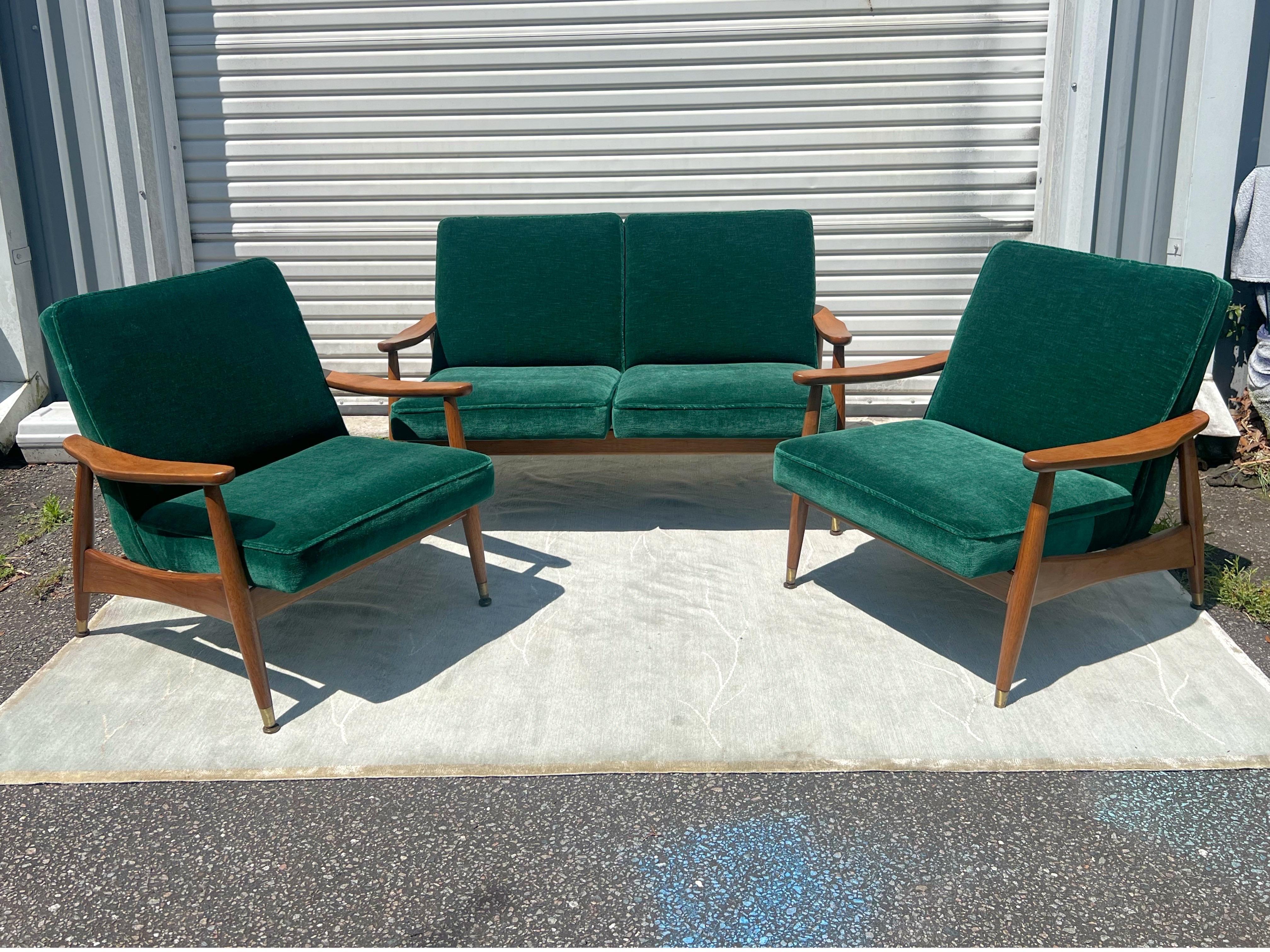 A stunning sculptural Danish 2 seater sofa in the style of Arne Vodder. Teak frame with subtly scooped and curved arms and a base that makes it appear to be floating. The cushions are attached to the sofa and are very sturdy and supportive. Please