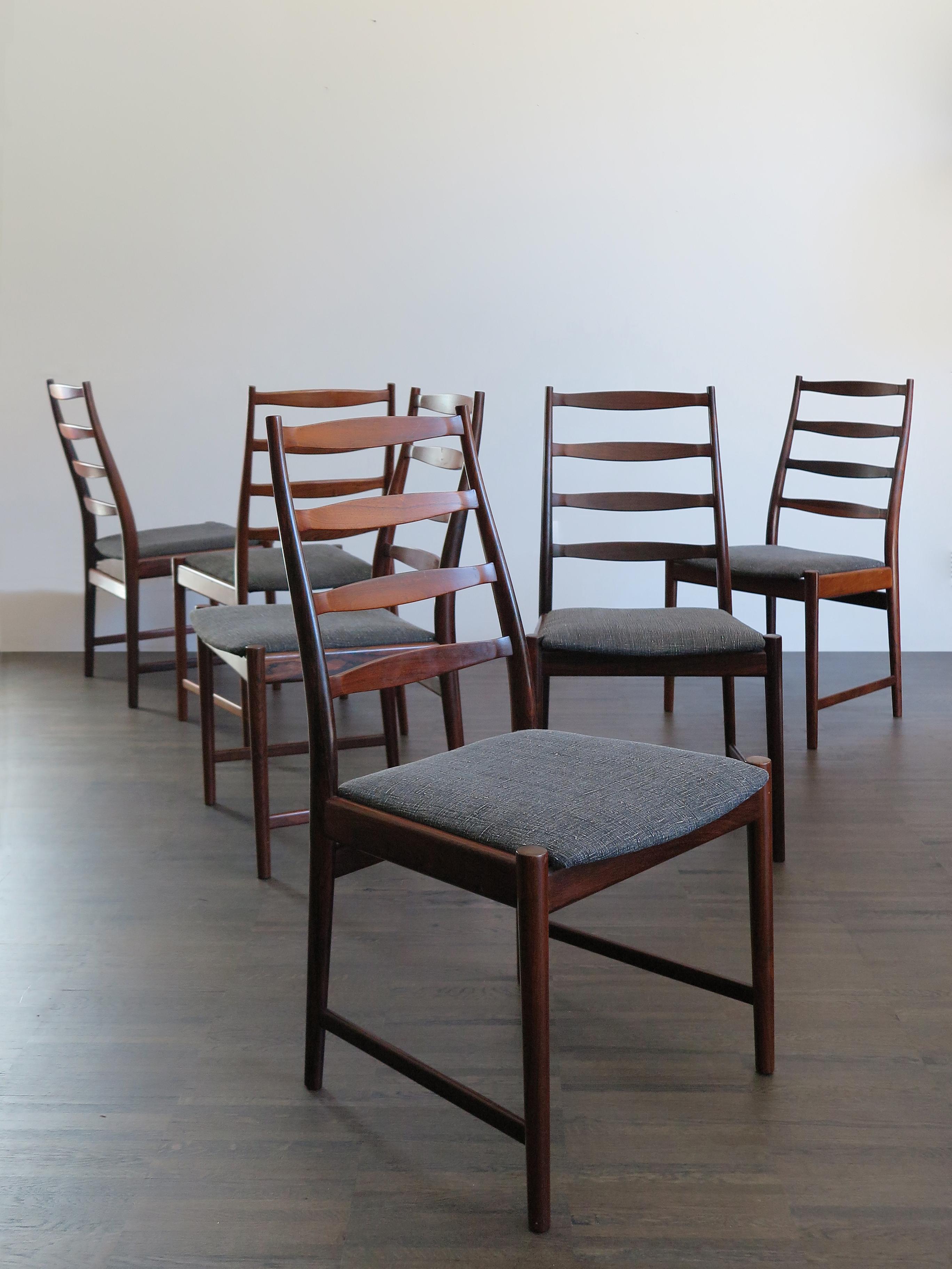 1960s set of six Danish solid rosewood dining chairs, designed by Arne Vodder, manufacturer’s logo printed on the bottom and new lining fabric.