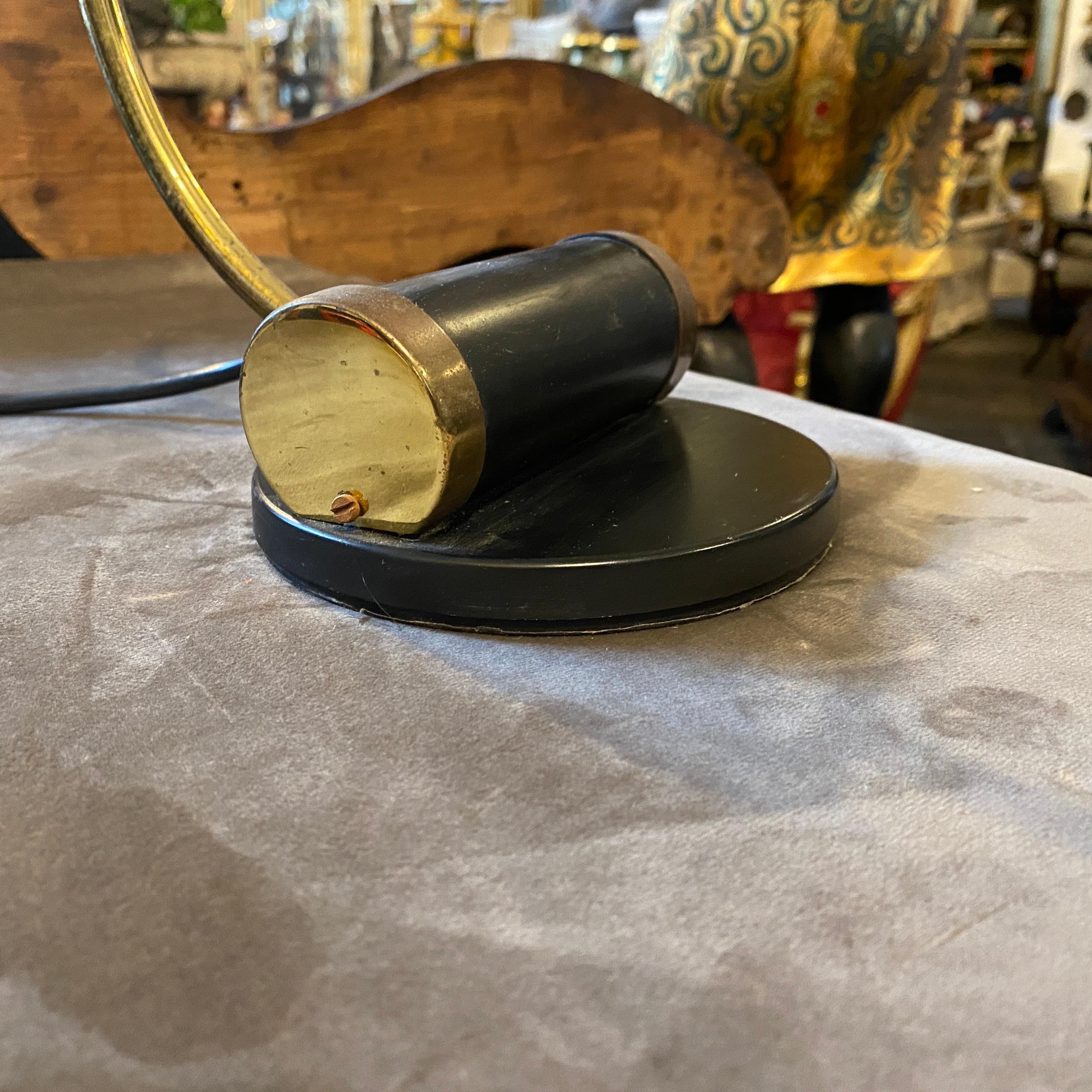 A black painted metal and brass table lamp made in Italy in the sixties, it works 110-240 volts and needs regular e14 bulb.