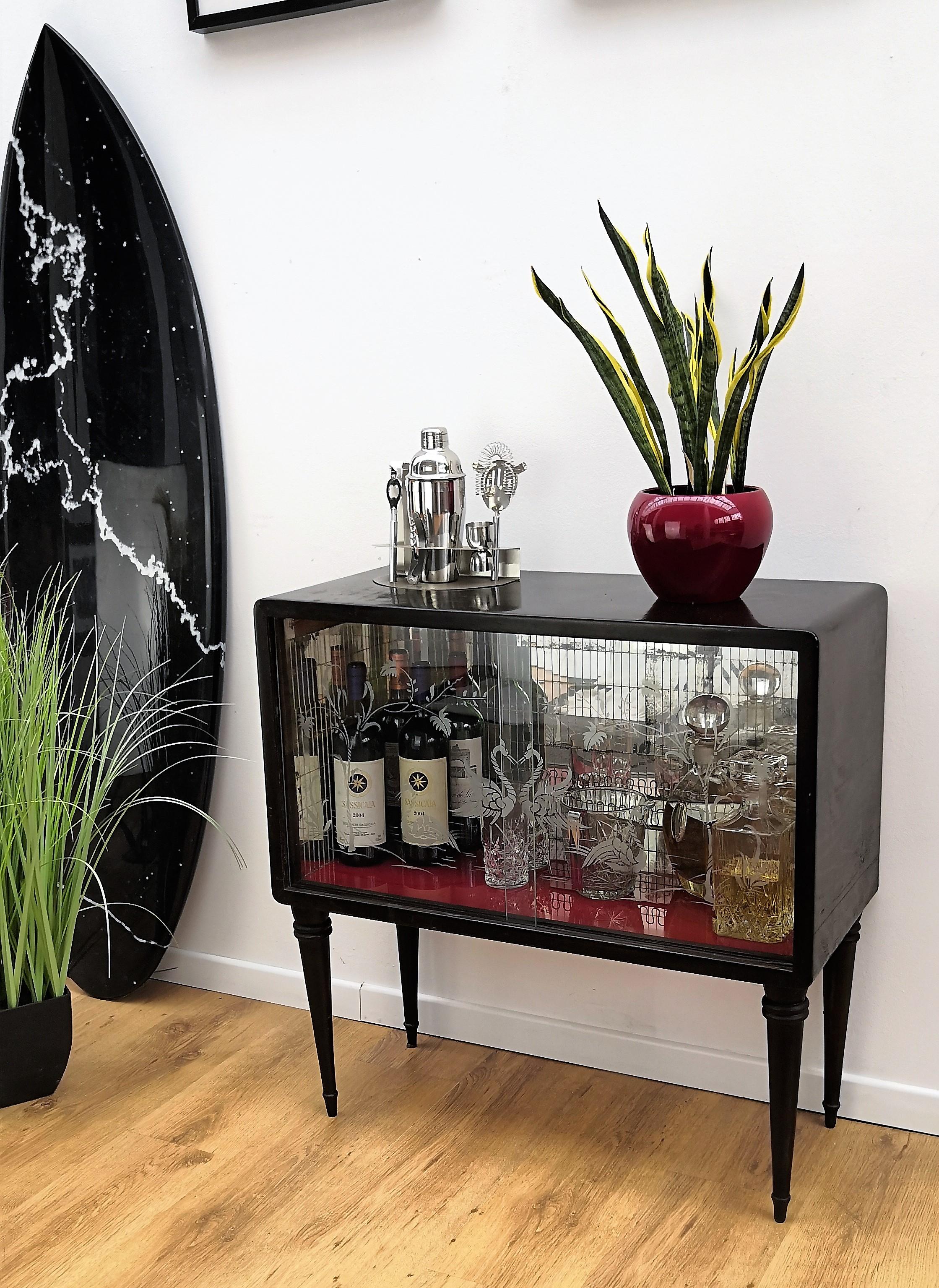 Very elegant Italian Art Deco Mid-Century Modern dry bar cabinet with two glass sliding doors and amazing interior part in mirrors mosaic. The glass doors have a botanical lagoon engraving with flamingoes. Small parts of the internal mirrors are