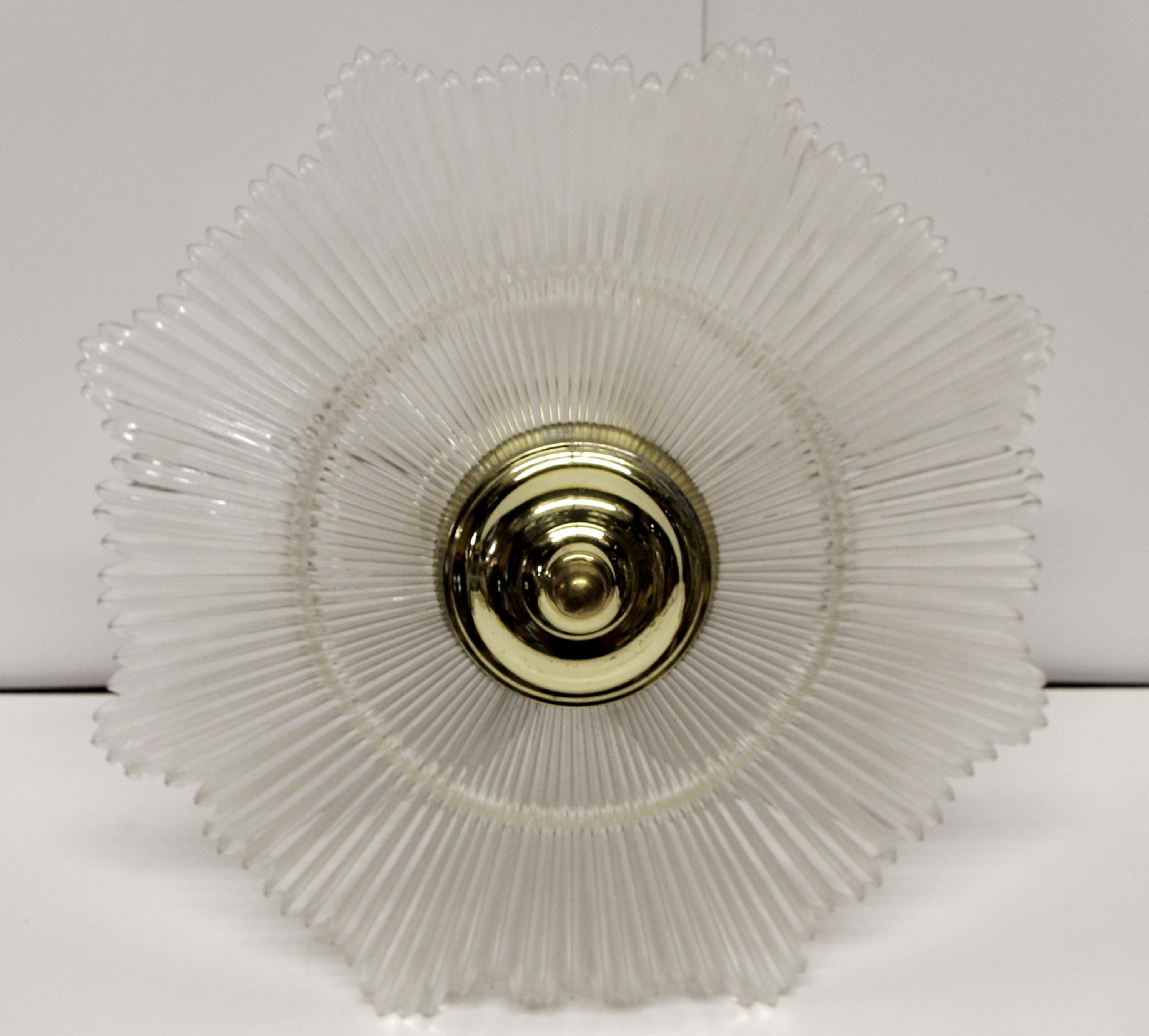 1960s Art Deco style three socket clear star burst crystal pendant light with a brass frame. This can be seen at our 400 Gilligan St location in Scranton, PA.