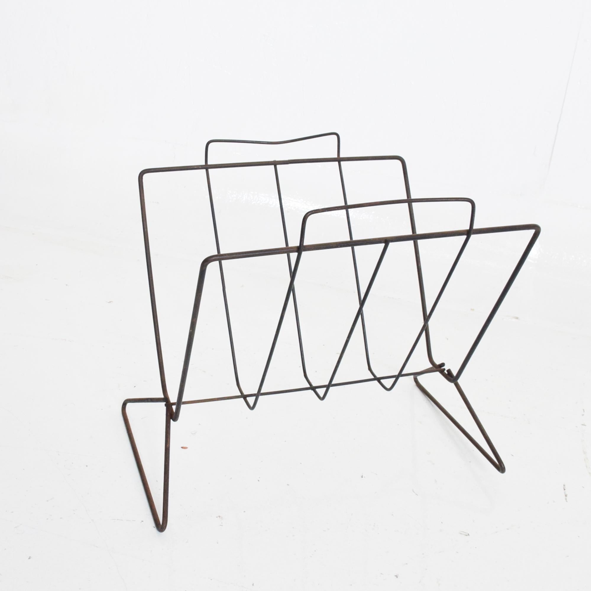 From AMBIANIC
Midcentury Modern sculptural iron in black magazine rack.
Style of Arthur Umanoff - George Nelson Era. USA circa 1960s.
Dimensions: 12 H x 17 W x 10 D inches
Original Unrestored Fair Vintage Condition. Wear and nicks present to the