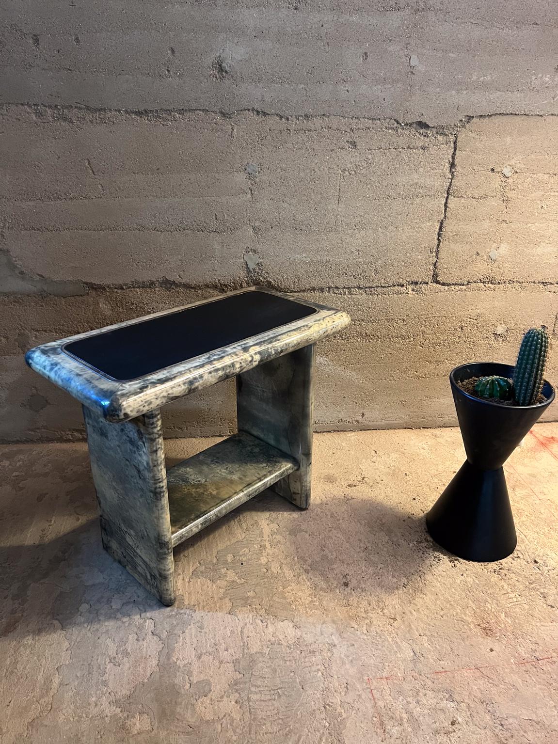 1960s Arturo Pani rectangular Side Tables in patinated brass, lacquered goatskin and leather. 
Goatskin displays color tan to dark gray. 
Tabletop is black leather with brass detail.
Unmarked attributed to Arturo Pani Mexico City
26.38 H x 16.38 D x