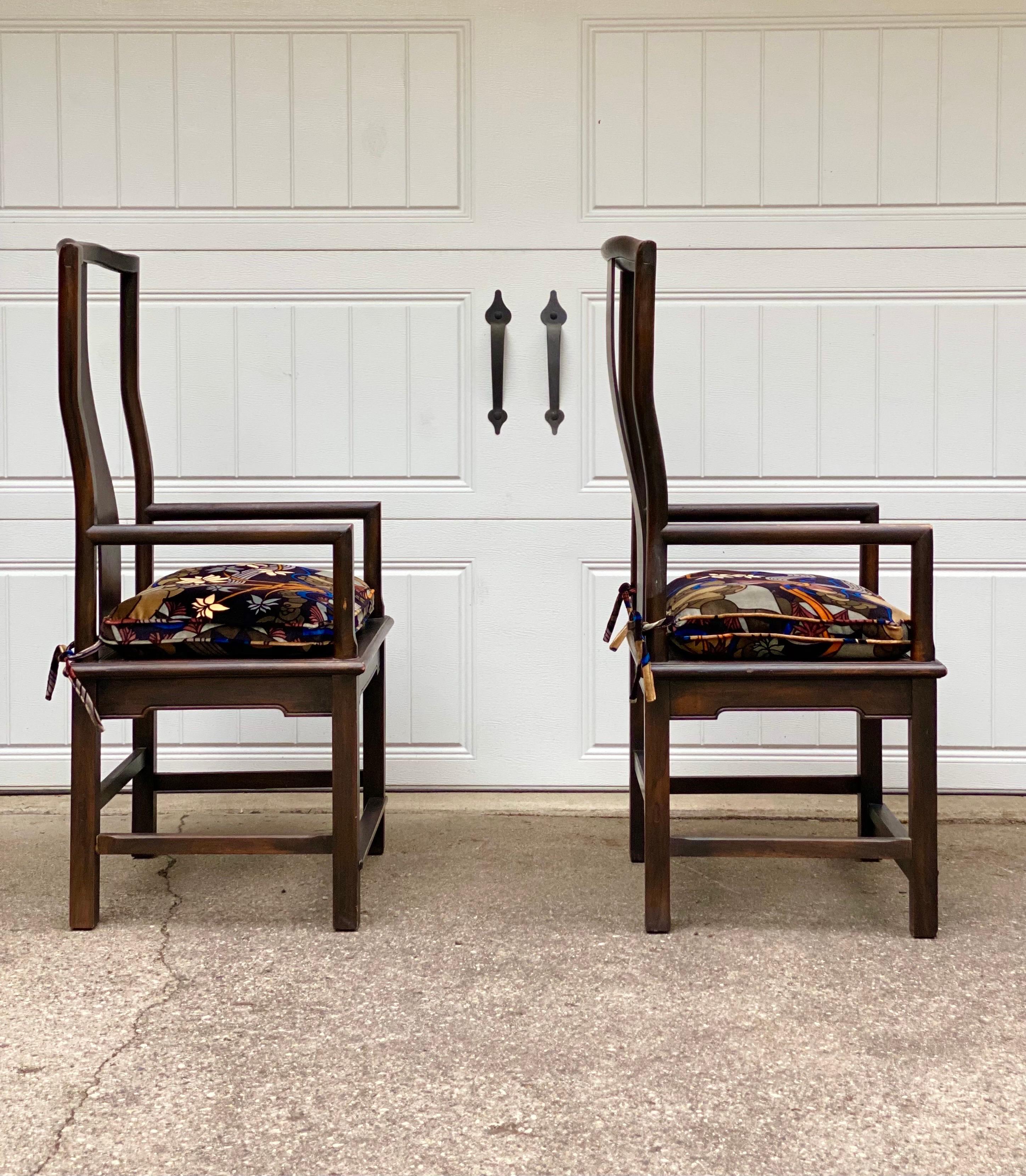 We are very pleased to offer a set of vintage chairs from the 1960s. This pair has a graceful and elegant appearance, reflecting the artistic sensibilities often found in Asian furniture. One distinctive feature is their splat back design, a solid