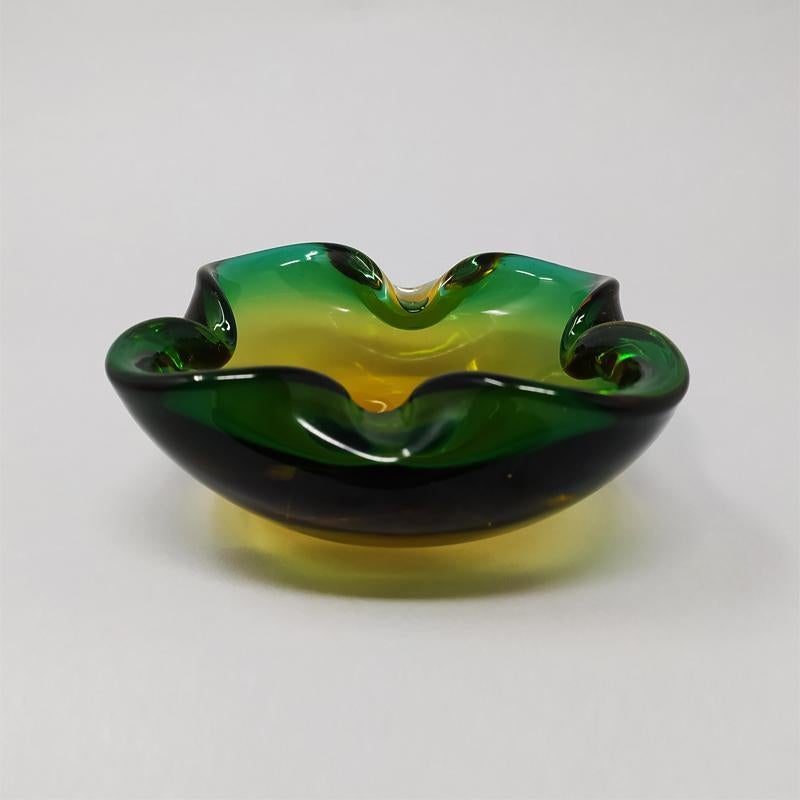 1960s Astonishing Big Green and Yellow Big Bowl Designed By Flavio Poli in Murano Sommerso Glass. A luxurious piece of art glass to decorate any living space which can also be used as a serve ware, vide poche or jewelry bowl. Made in italy
The item