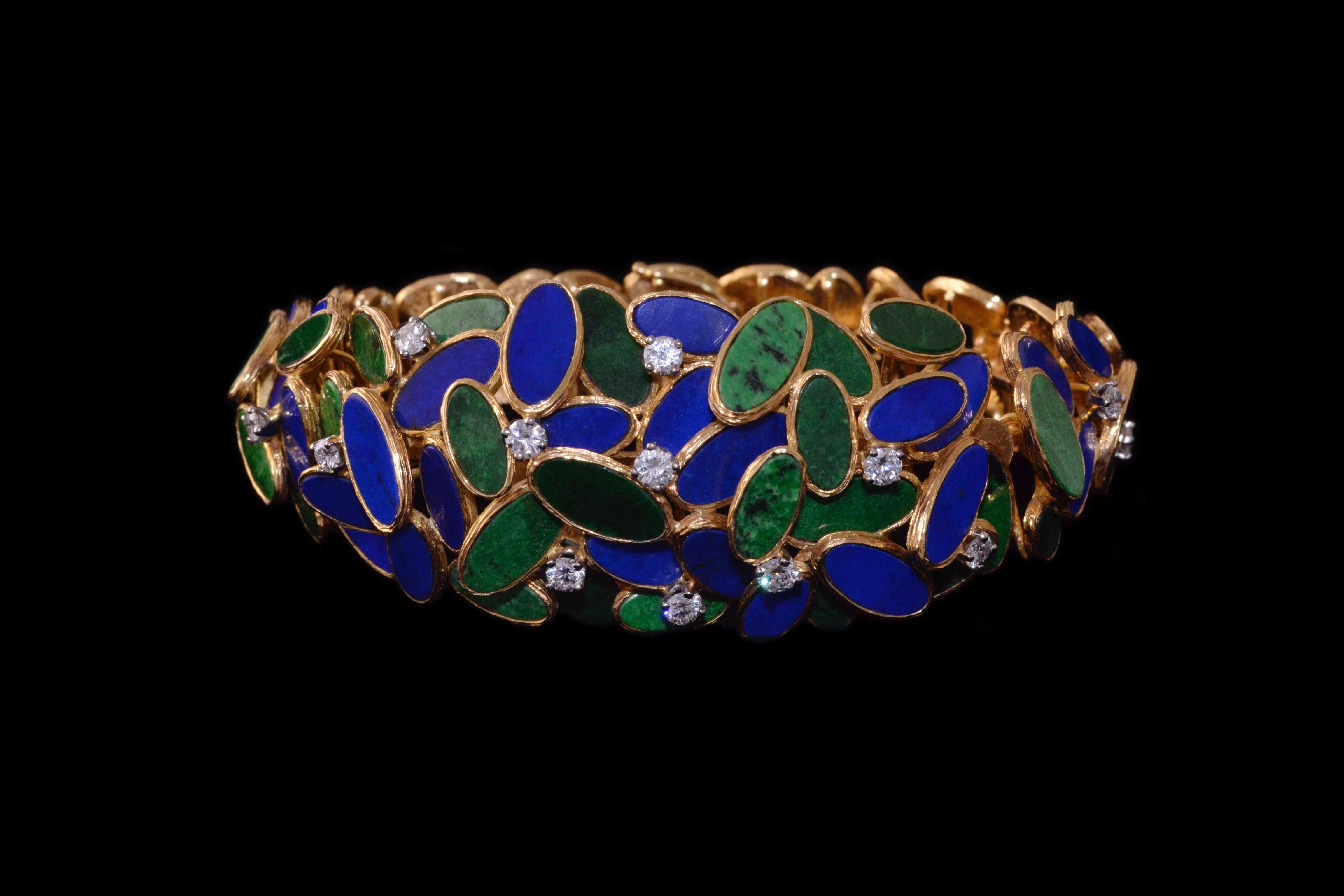 A flexible maw sit sit, lapis, diamond and 18 karat gold bracelet, by Augustin Julia-Plana, c.  1960.

This bracelet is stamped design Julia-Plana, 750, S, and measures approximately 7.4 inches long.

Julia-Plana's unique and highly regarded designs