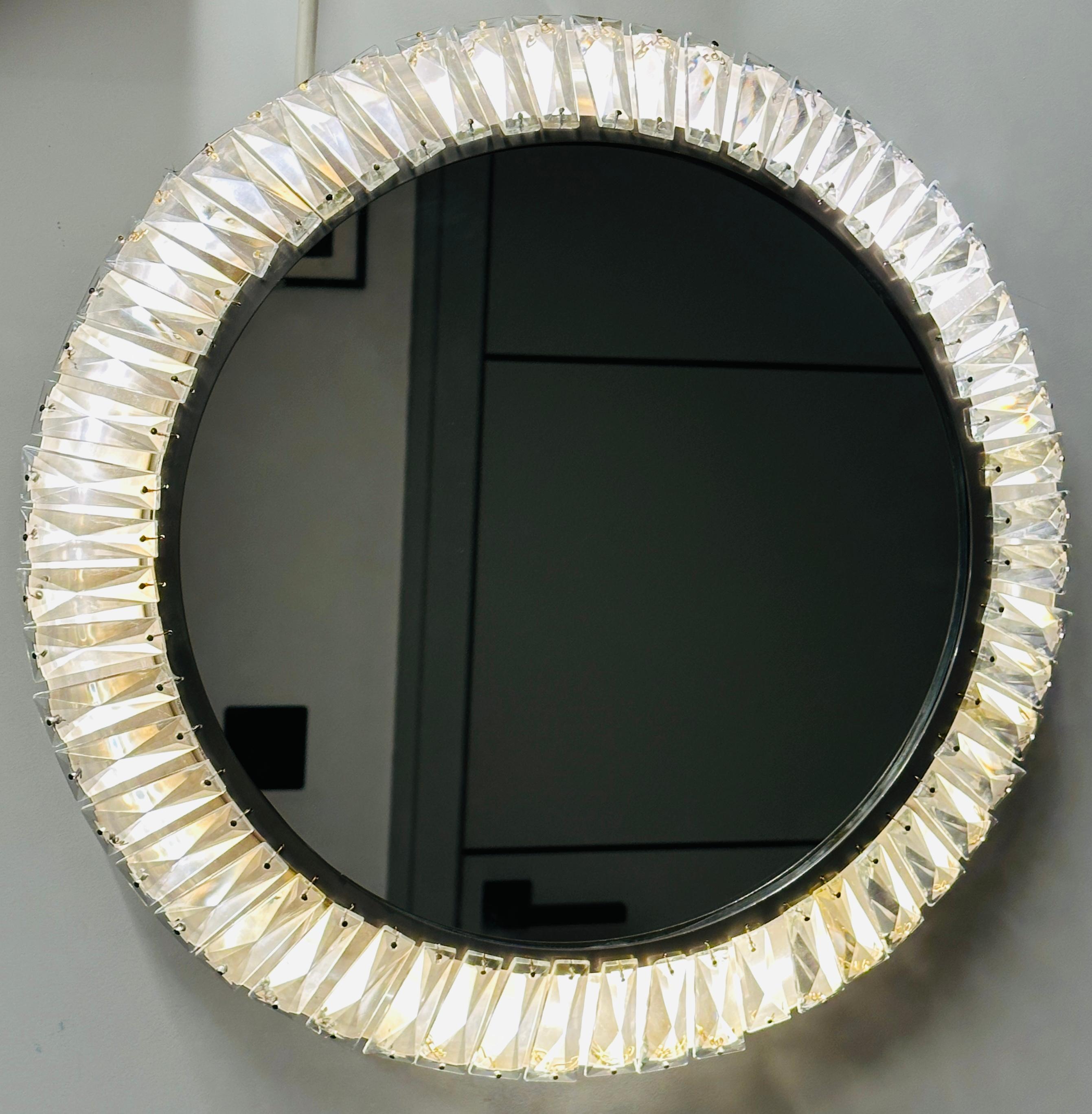 This exquisite vintage mirror is a stunning example of Mid Century Modern design.  Designed and handcrafted in Vienna by Austrian manufacturer Bakalowits & Söhne during the 1960s. This highly sought-after piece seamlessly blends functionality with