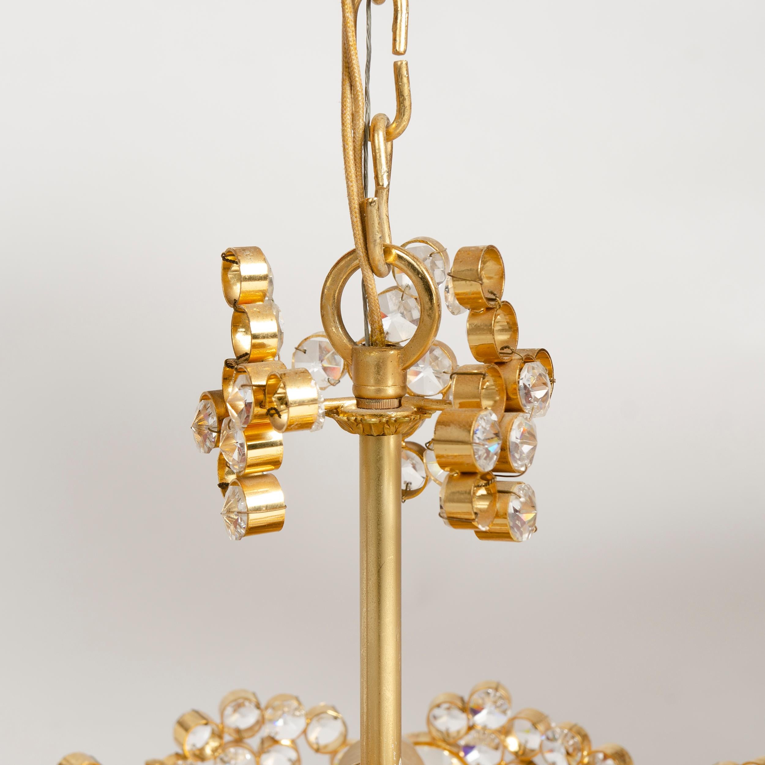 A petite, specular crystal and brass chandelier.