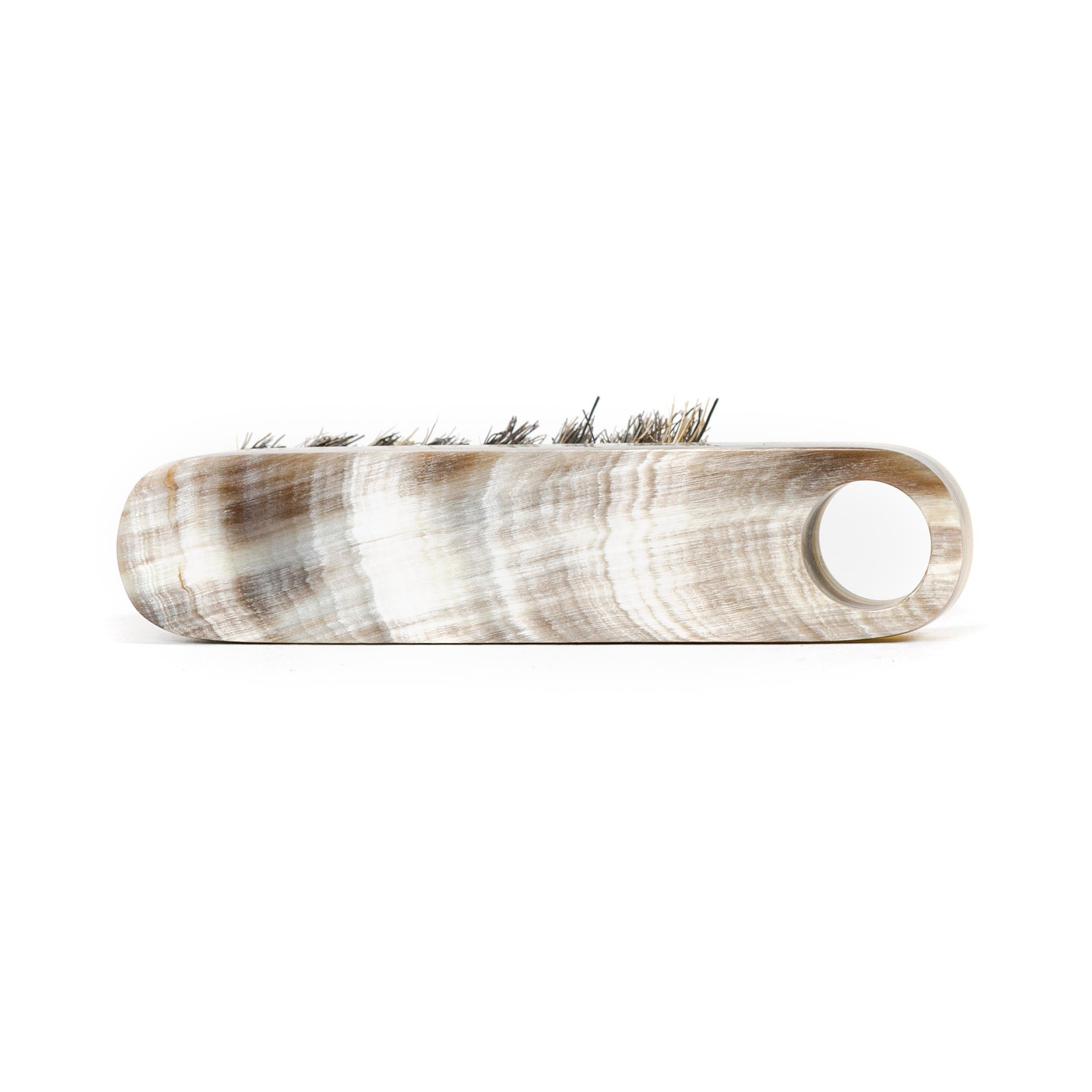 An elegant brush hand carved from cow Horn with naturally occurring variations in color and pattern.