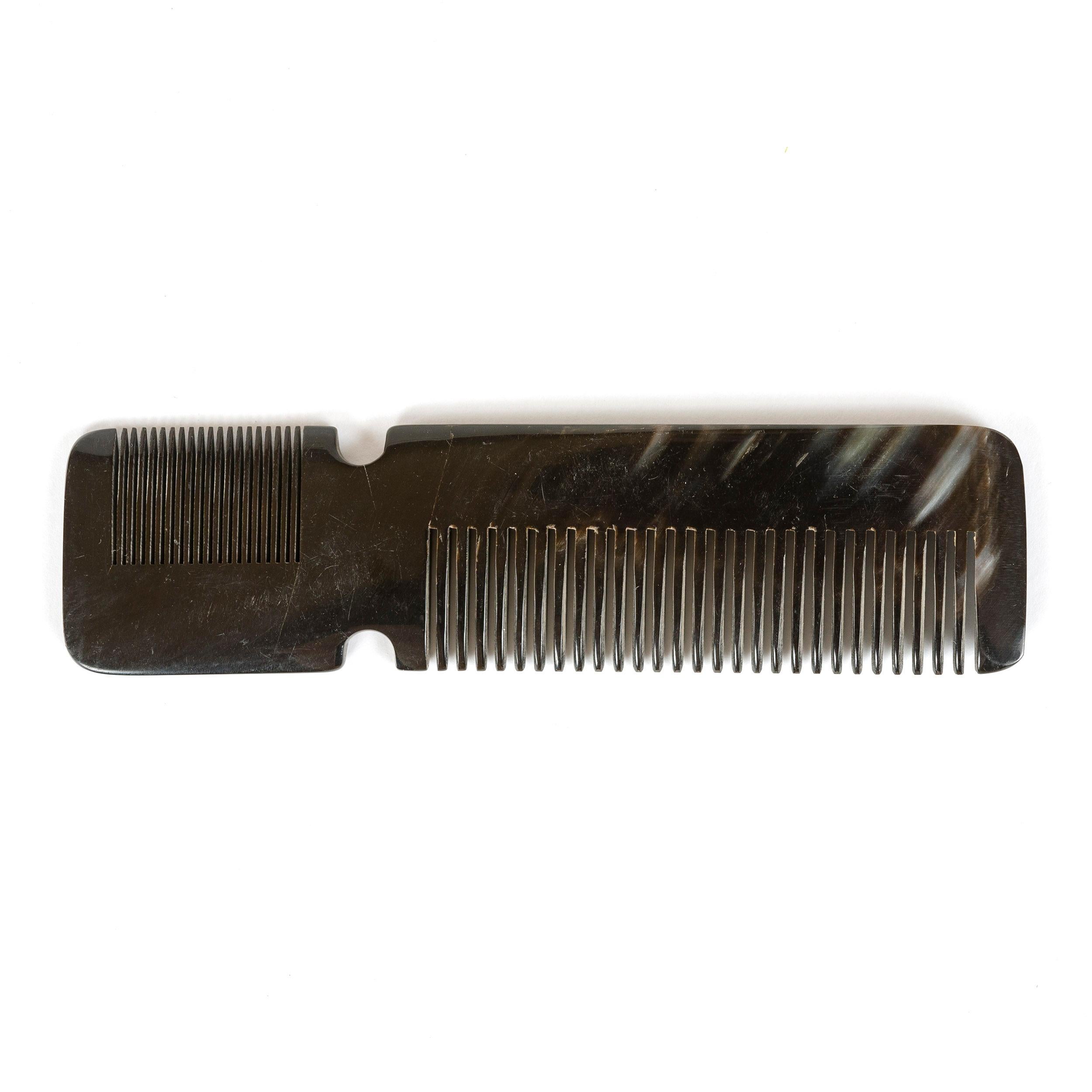 An elegant comb hand carved from cow horn with naturally occurring variations in color and pattern.