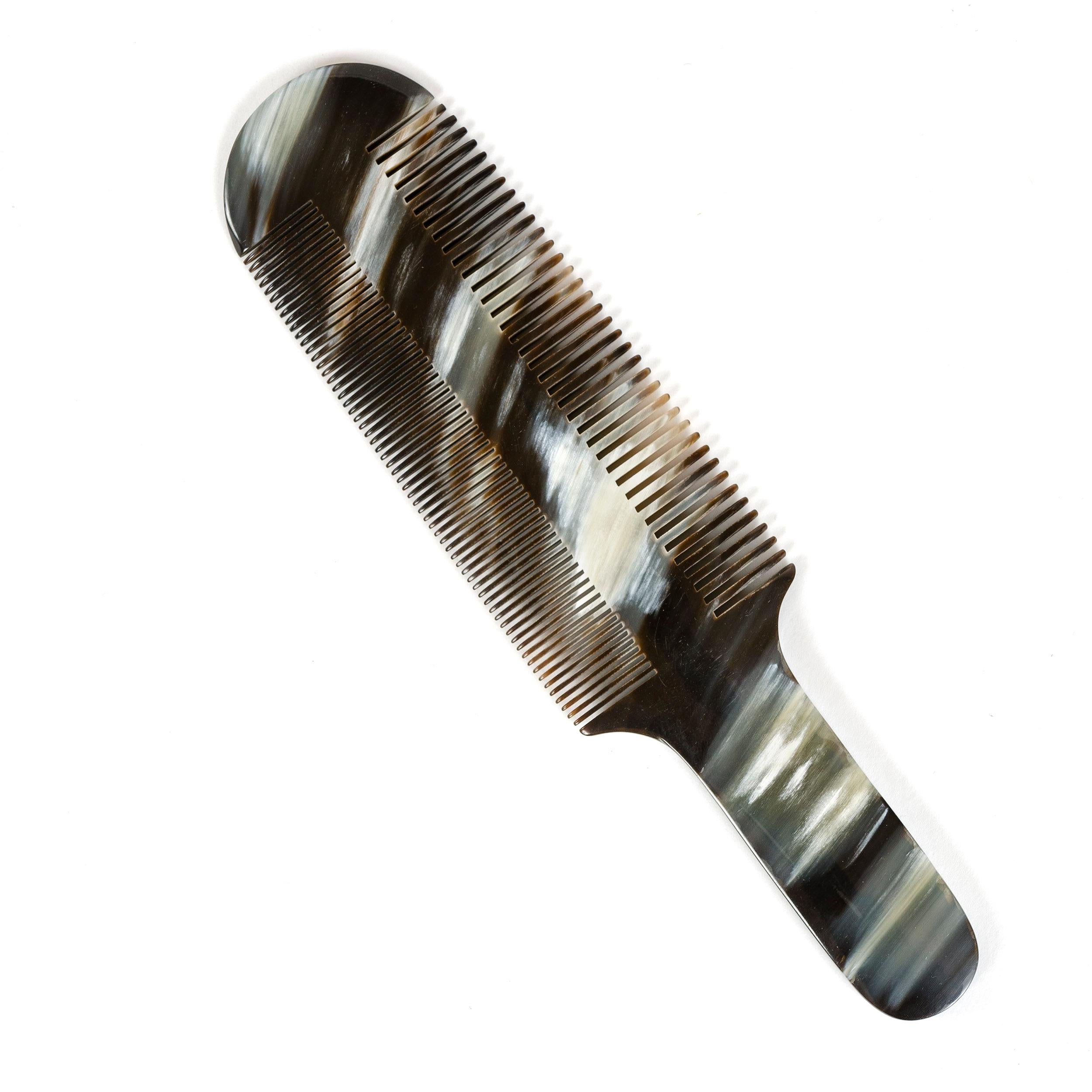 An elegant comb hand carved from cow horn with naturally occurring variations in color and pattern.