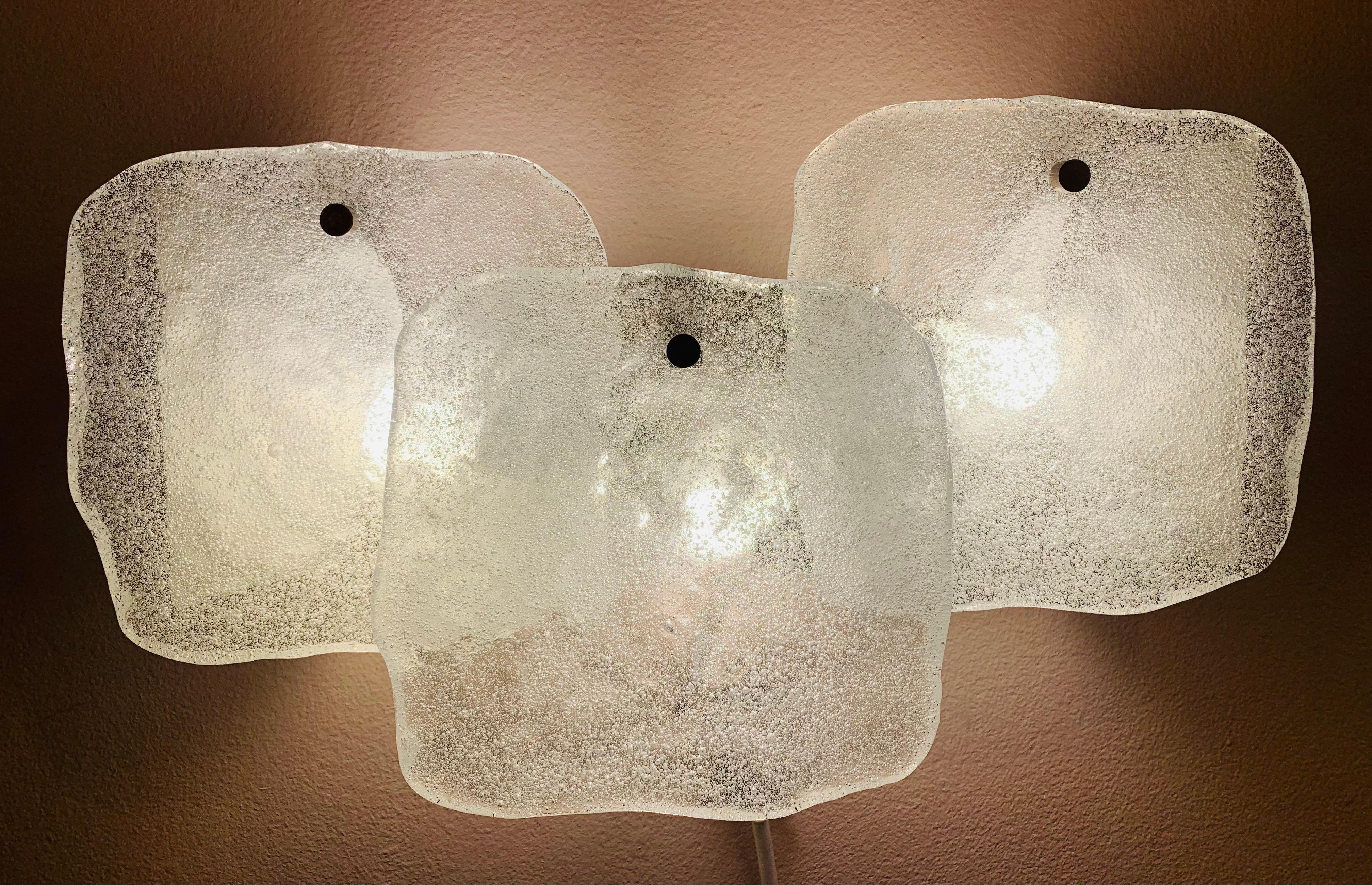 1960s, Austrian, Kalmar Franken KG, wall lights or wall sconces. The three, square, pieces of thick, frosted, iced-glass are suspended from a steel metal frame by a single chrome feature screw at the top of each one. Three E14 screw in candle or