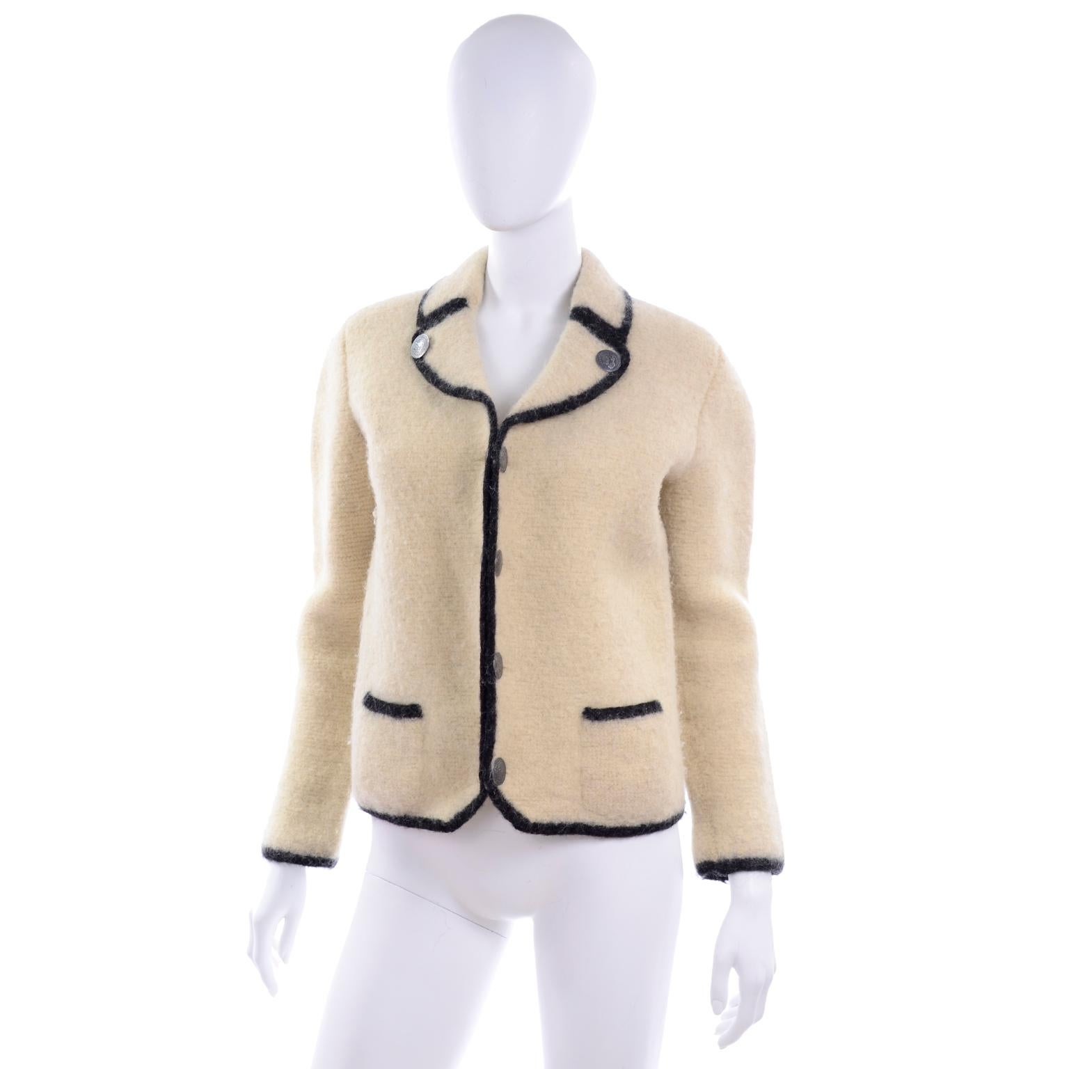 This is a beautiful boiled wool button front jacket in ivory wool. This lovely wool jacket is very thick and has brushed nickel buttons that are double sided, a notched collar and small front pockets.  The measurements are taken from the outside and