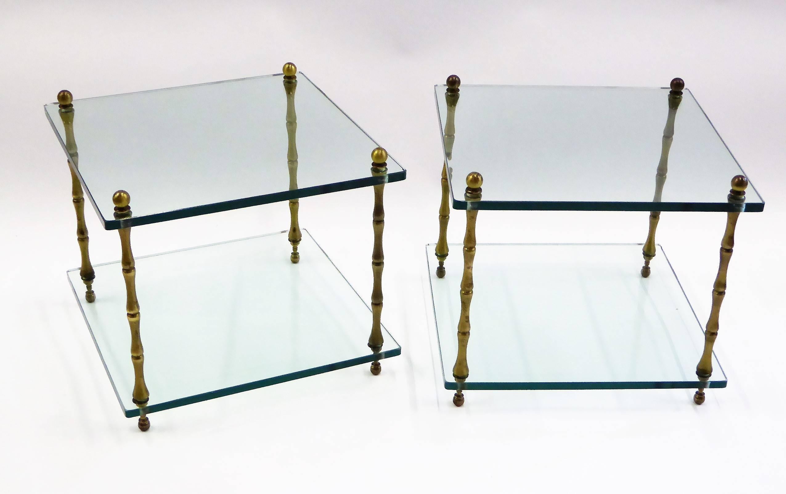 Elegant and fun brass legged faux bamboo glass tables perfect as occasional and side tables by Baker. Featuring two glass levels each with 1/2 inch thick glass supported by four upright brass faux bamboo shaped legs. 1960s Maison Bagues style end