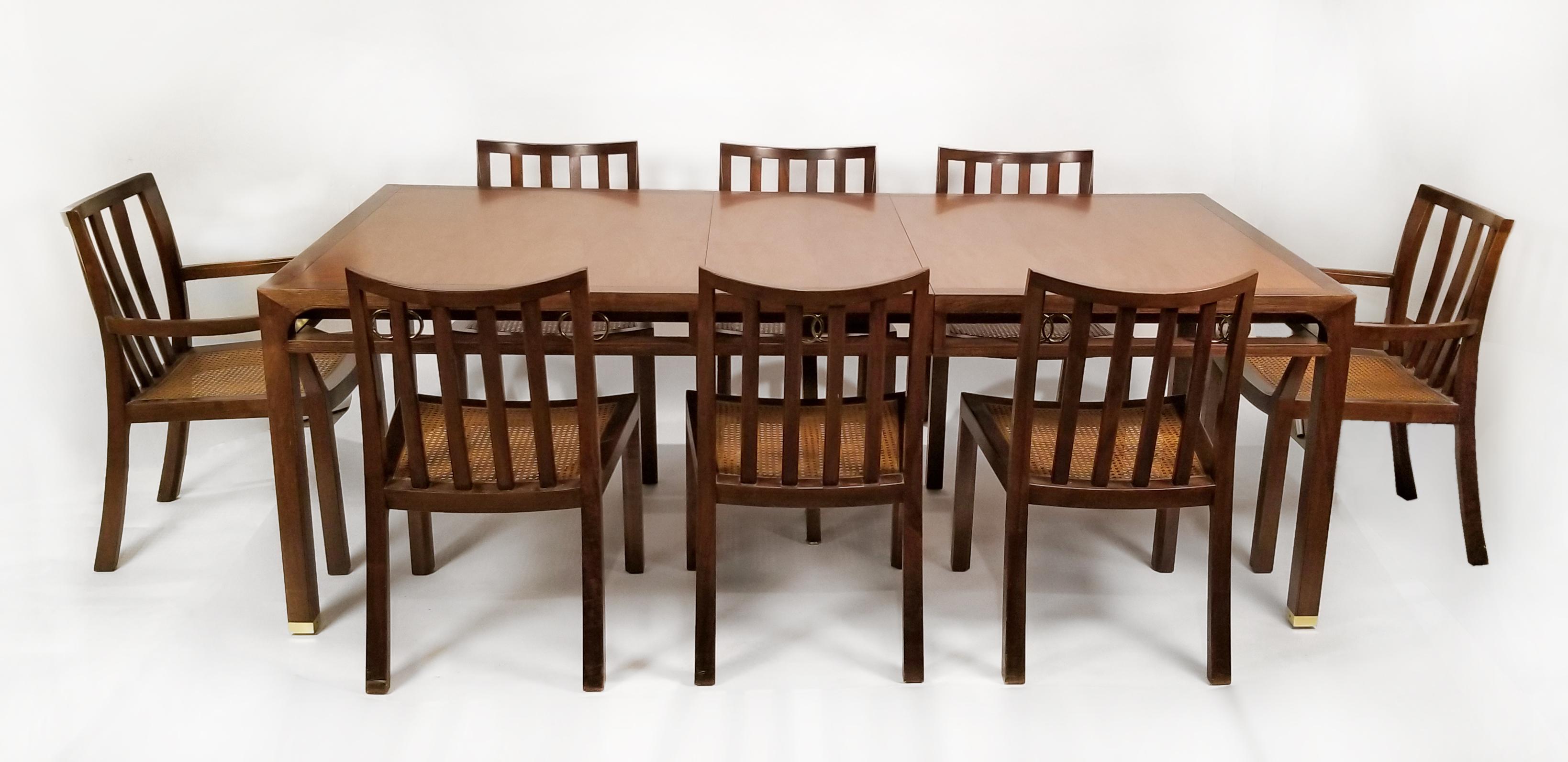 Beautiful Far East collection dining set designed by Michael Taylor for Baker. The dining set is in very good original condition and consists of a walnut extension table with three leaves, six side chairs, and two armchairs.

This set was acquired