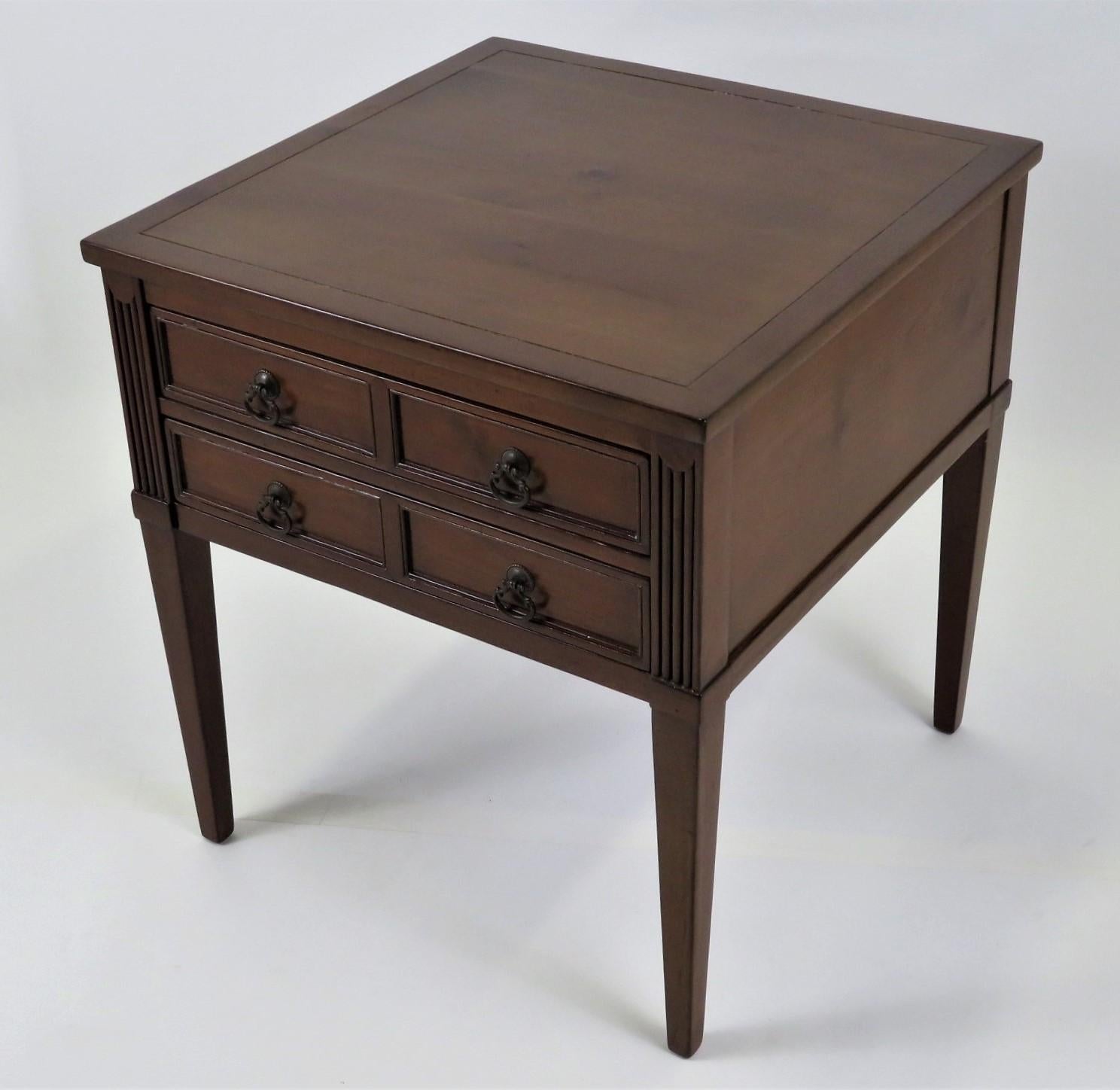 Fine Baker Furniture two drawer transitional style french provincial bedside or end table. With subtle fluted carving on the front drawer side, it has earring drop pulls. A knotty cherry wood is employed to fine use. Restored