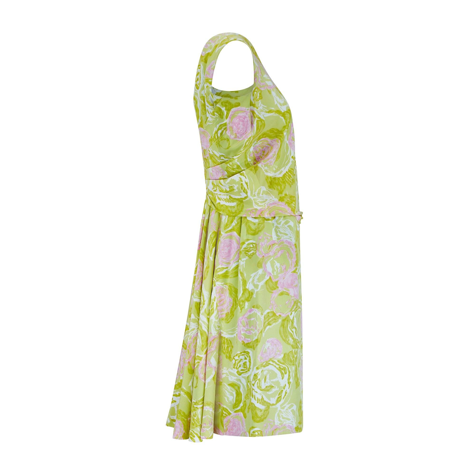 This pretty haute couture dress is one of Balestra’s earlier designs - we believe it dates to the mid to late 1960s. The beautiful silk fabric shows a swirling, painterly pattern of roses in chalky pink and white set against an eye-catching