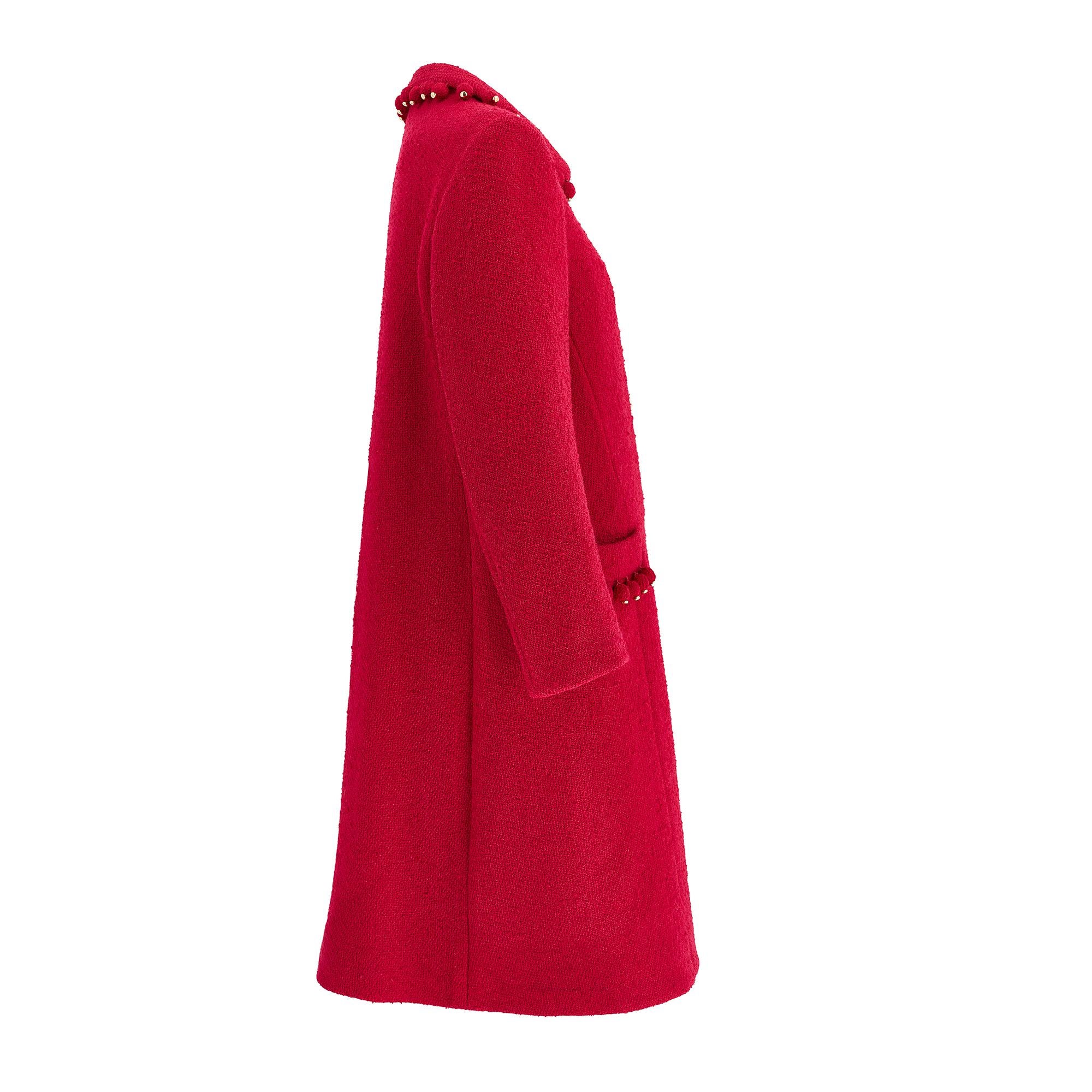 Un superbo cappotto a 3/4 in lana bouclé rossa di Pierre Balmain Couture del 1960.  Balmain studiò architettura insieme a design di abiti all'École des Beaux-Arts negli anni '30 e lavorò con un giovane Christian Dior e Hubert de Givenchy presso