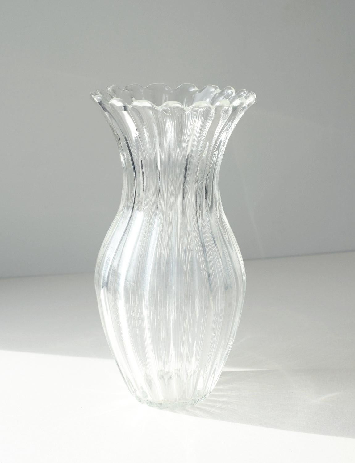 A hand-blown transparent glass Murano glass vase in the style of Barovier. It has a wonderful petal-like opening at the top, reflects the light beautifully and is in super condition considering its age.