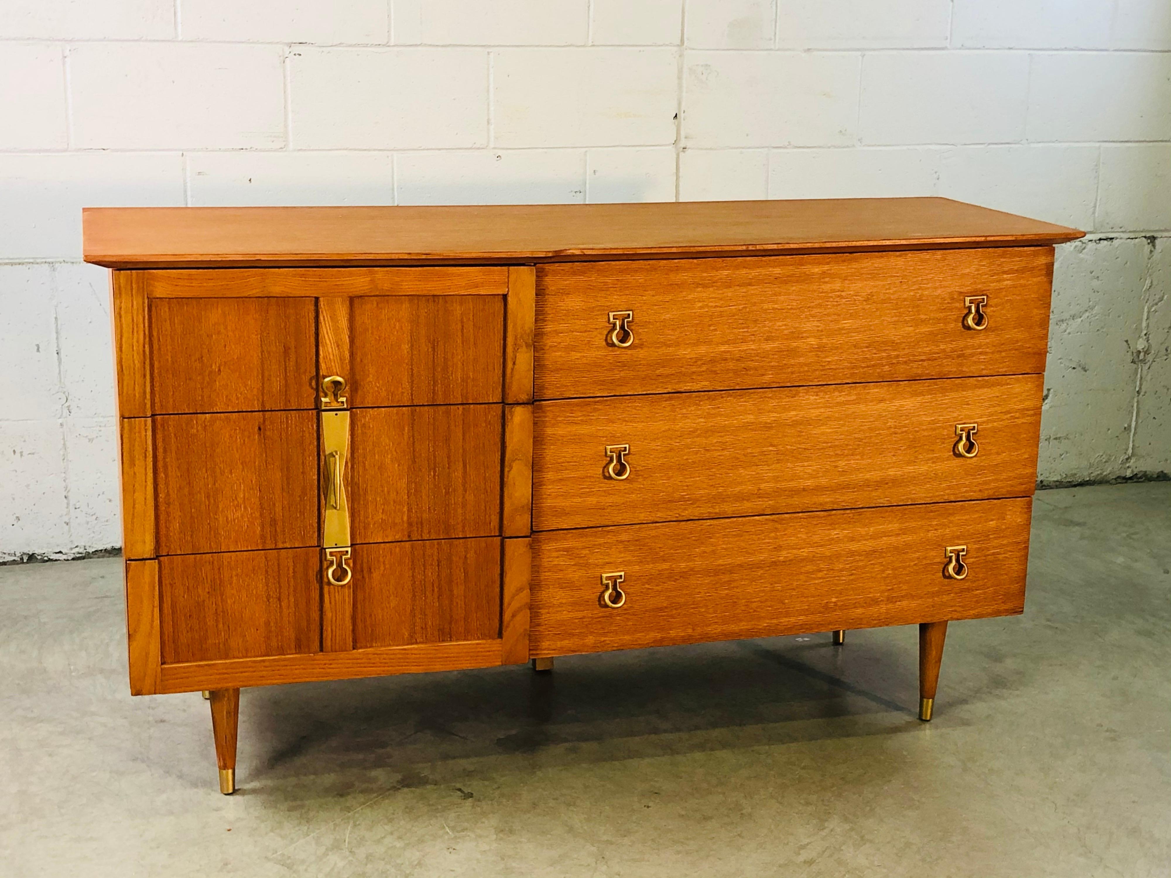 Vintage 1960s oak wood six drawer dresser by Basic-Witz. The dresser has brass accent pulls and is in newly refinished condition. Marked inside.
