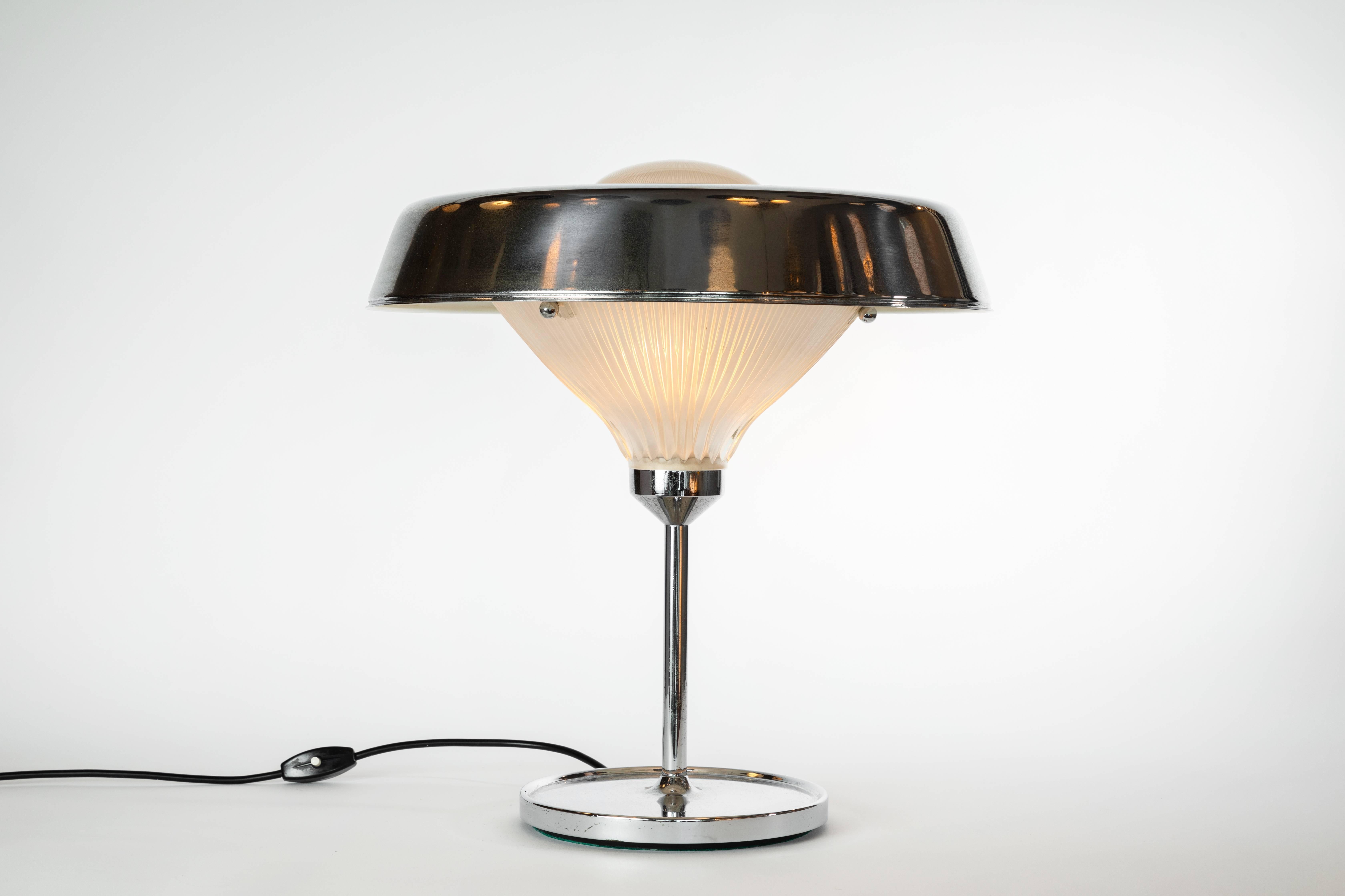 B.B.P.R 'Ro' table lamp for Artemide. Executed in chromed brass and pressed glass and designed by Lodovico Barbariano di Belgiojoso, Enrico Peressutti, Ernesto N. Roger for Artemide, Italy, circa 1962.

Not UL listed, but available upon request.