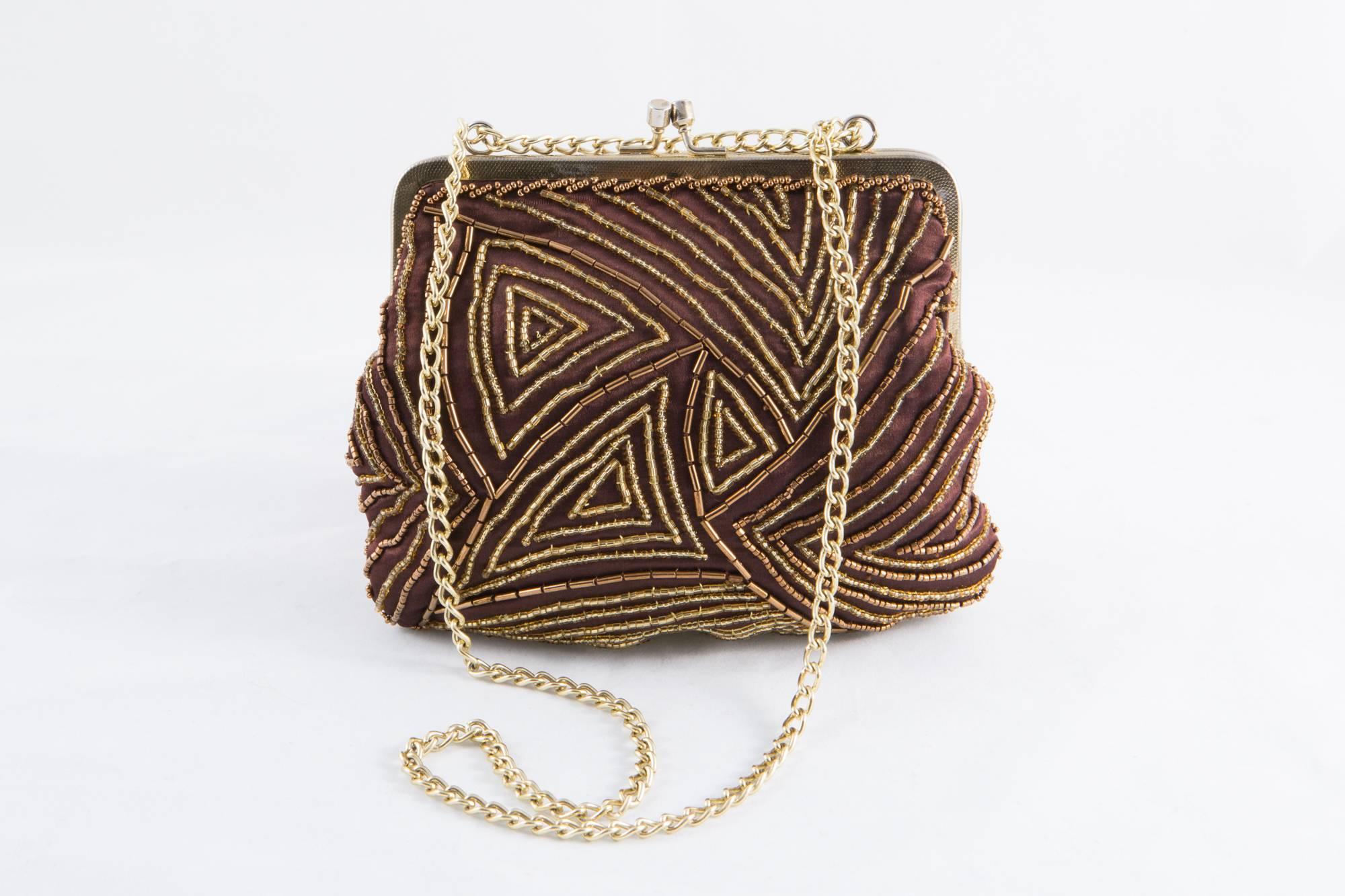 Brown silk satin evening small beaded bag featuring a gold tone hardware, a gold tone chain, a top opening, a yellow silk satin lining, a small inside pocket. 
In good vintage condition. Made in France.
Measurements:7in. (18cm) X 6.2in. (16