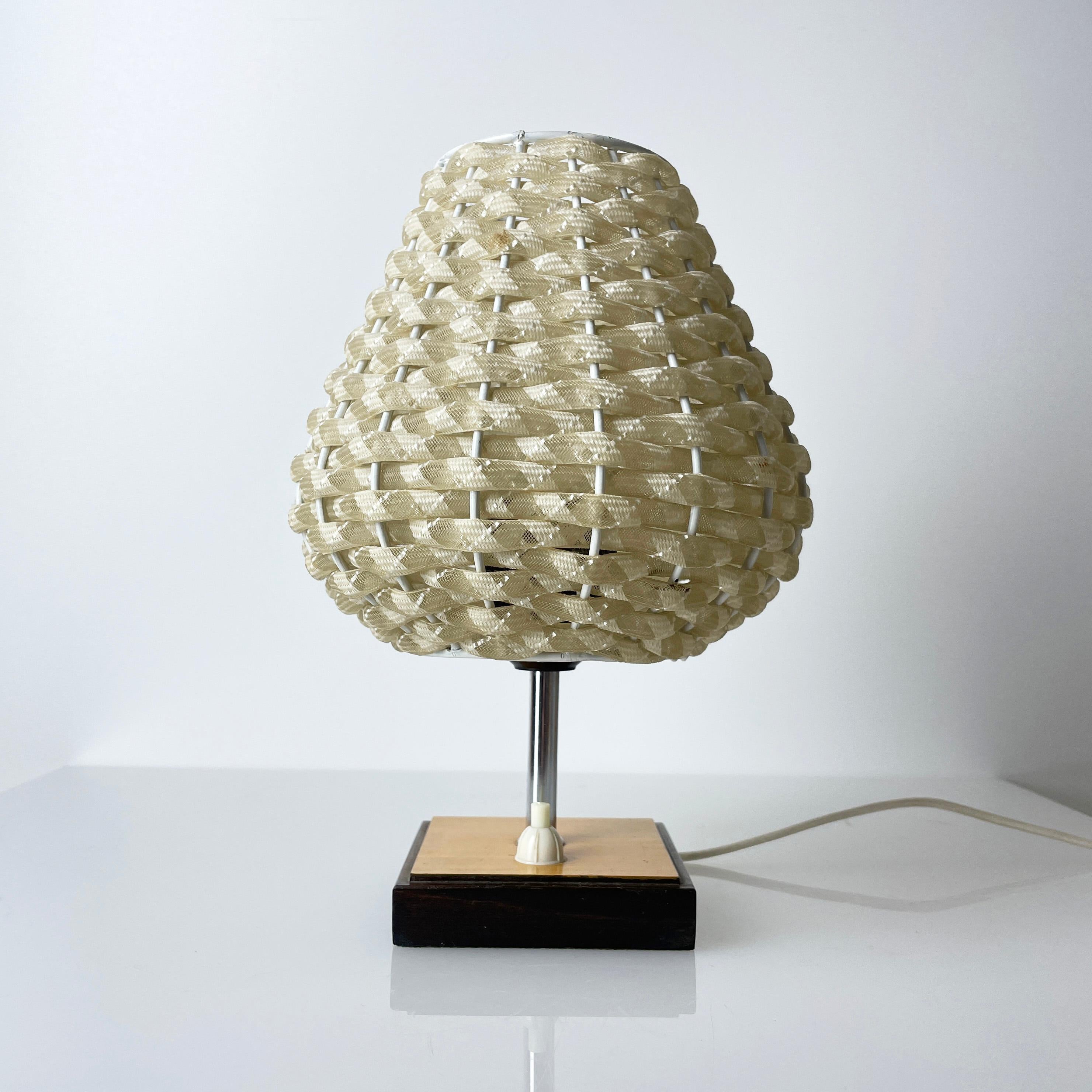 Beautiful 1960's Bedside Table Lamp with synthetic shade set on a solid wooden base. Adjustable light fitting. Synthetic cream shade gives a warm indirect light. Ideal for bedside lighting. 
Measurements: Height: ca. 23cm  Diameter : 20cm  
Colour: