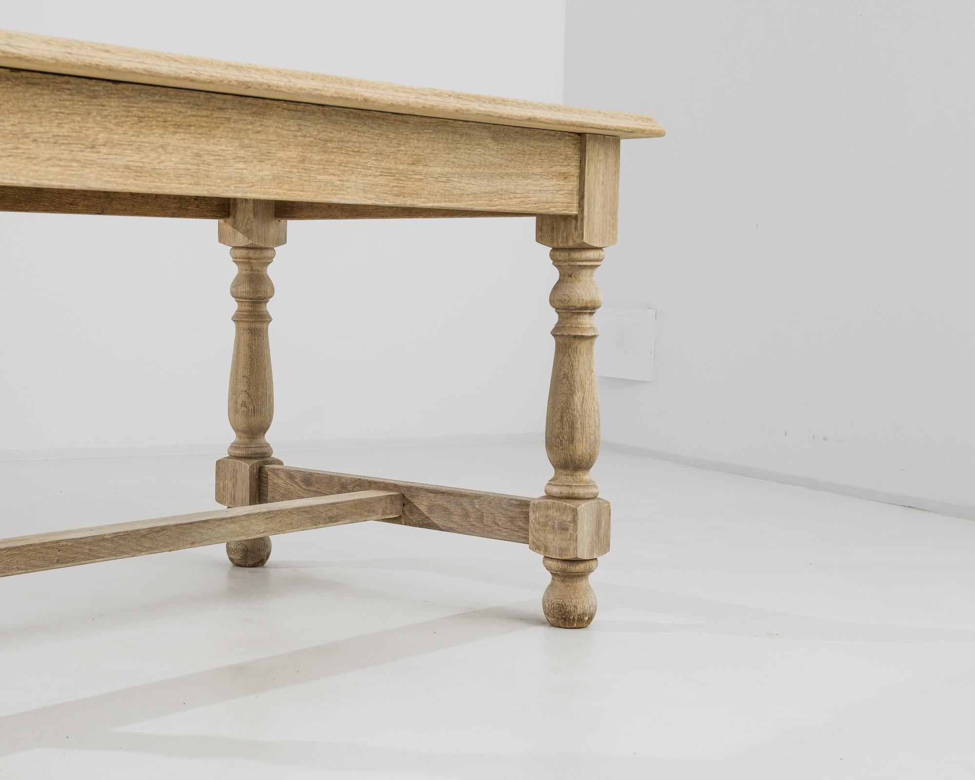 Step into the mid-century charm of a 1960s Belgian Bleached Oak Table, a unique piece that seamlessly marries style with craftsmanship. The table boasts a distinctive bleached oak finish, adding a touch of warmth to your space. Hand-carved wood