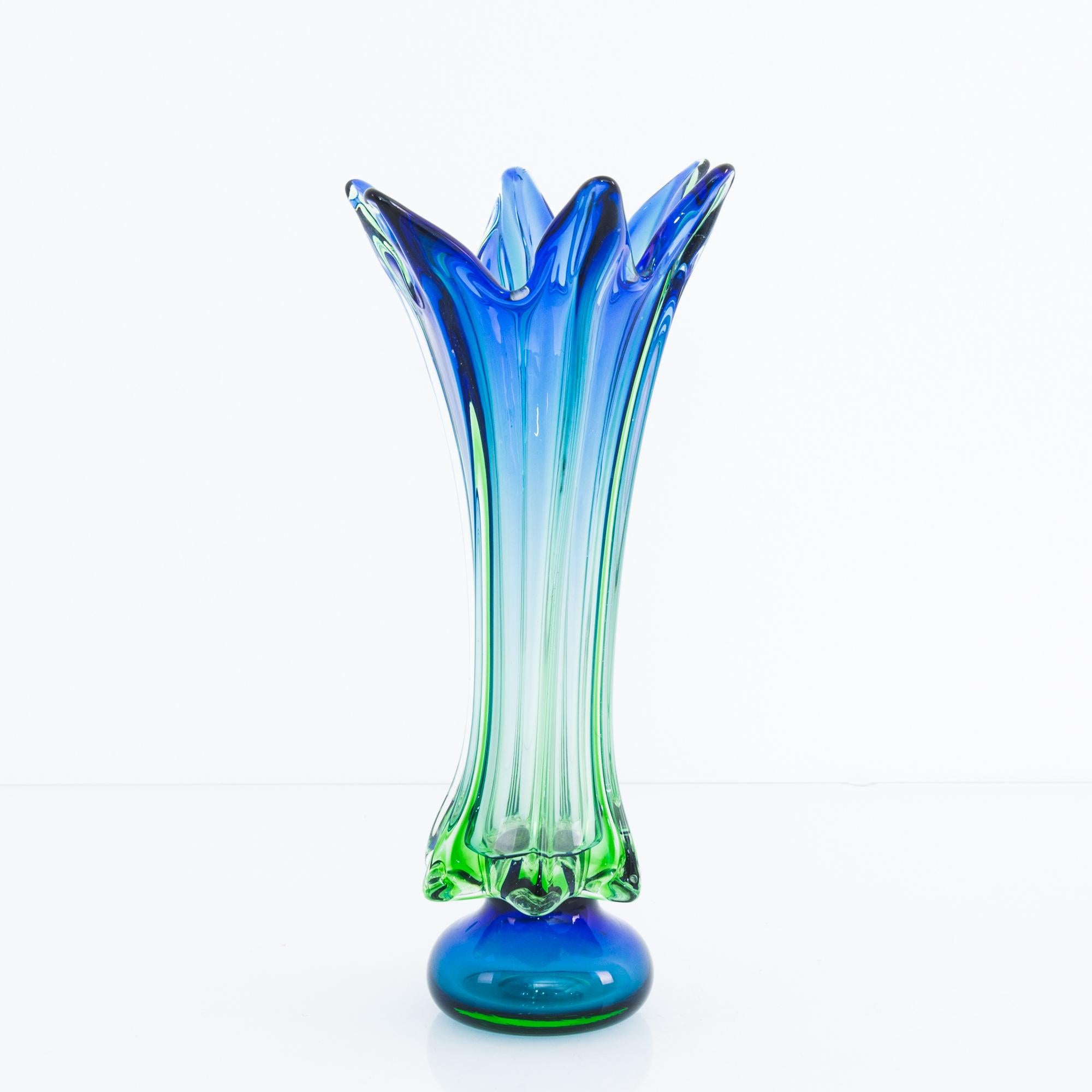 A glass bowl from Belgium, produced circa 1960. An elegant, hand blown decorative glass vase in an evocative blue-green gradient. Like a dancer caught in motion as she moves through maneuvers: arms stretched out wide in second position, while being