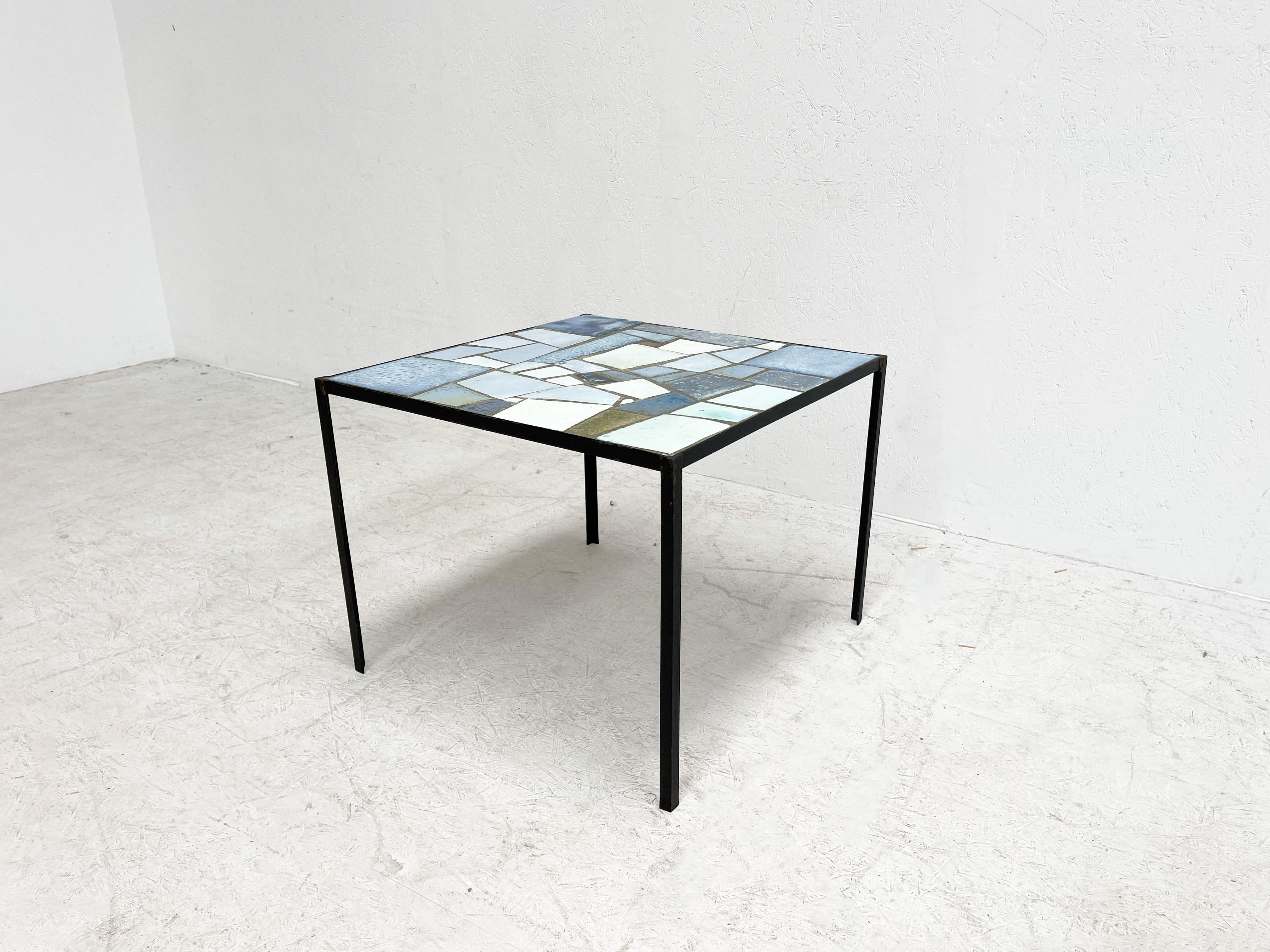 Abstract coffee table by Belgian Ceramic artist Louise Servaes. This table was designed in the 1970s. It displays an abstract pattern with very nice blue stone inlay.
 
Louise Servaese was a very well known and renowned artist with many