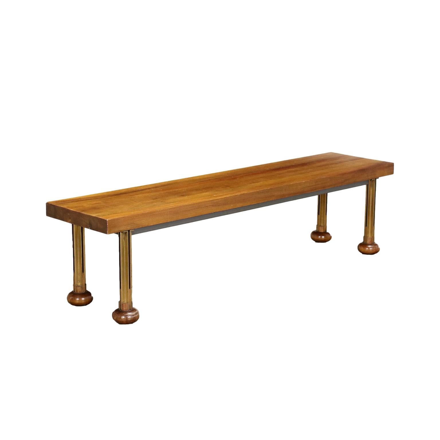 Italian manufacturing center bench from the 1960s. Composed of uprights with brass profiles ending with 'onion' feet, it is in walnut veneered wood.