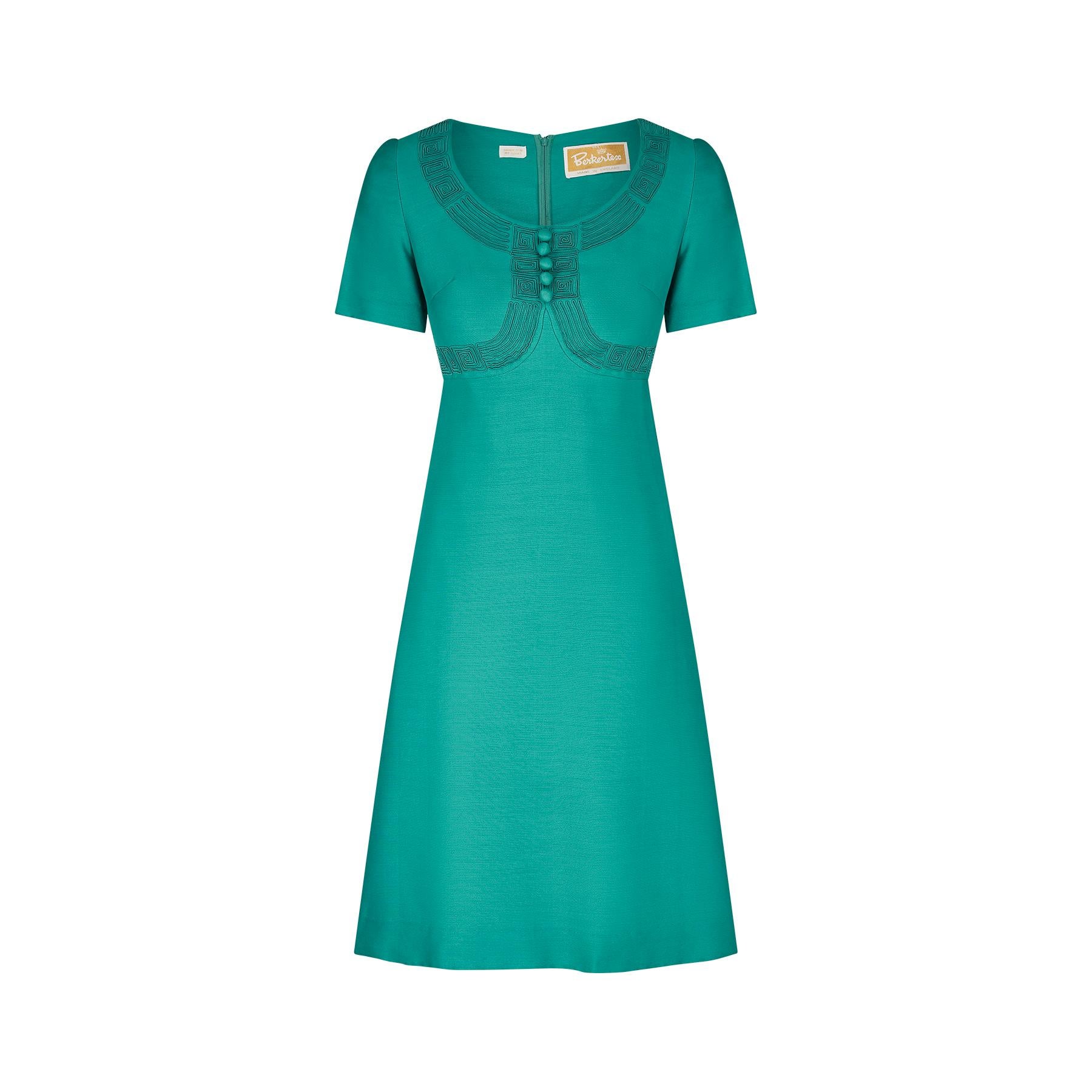 This 1960s original Berkertex dress is in a striking shade of emerald green and has an unusual decorative trompe-l'œil bodice that looks like a bolero jacket is being worn.  This is in fact a patterned series of scrolling soutache work. The fabric