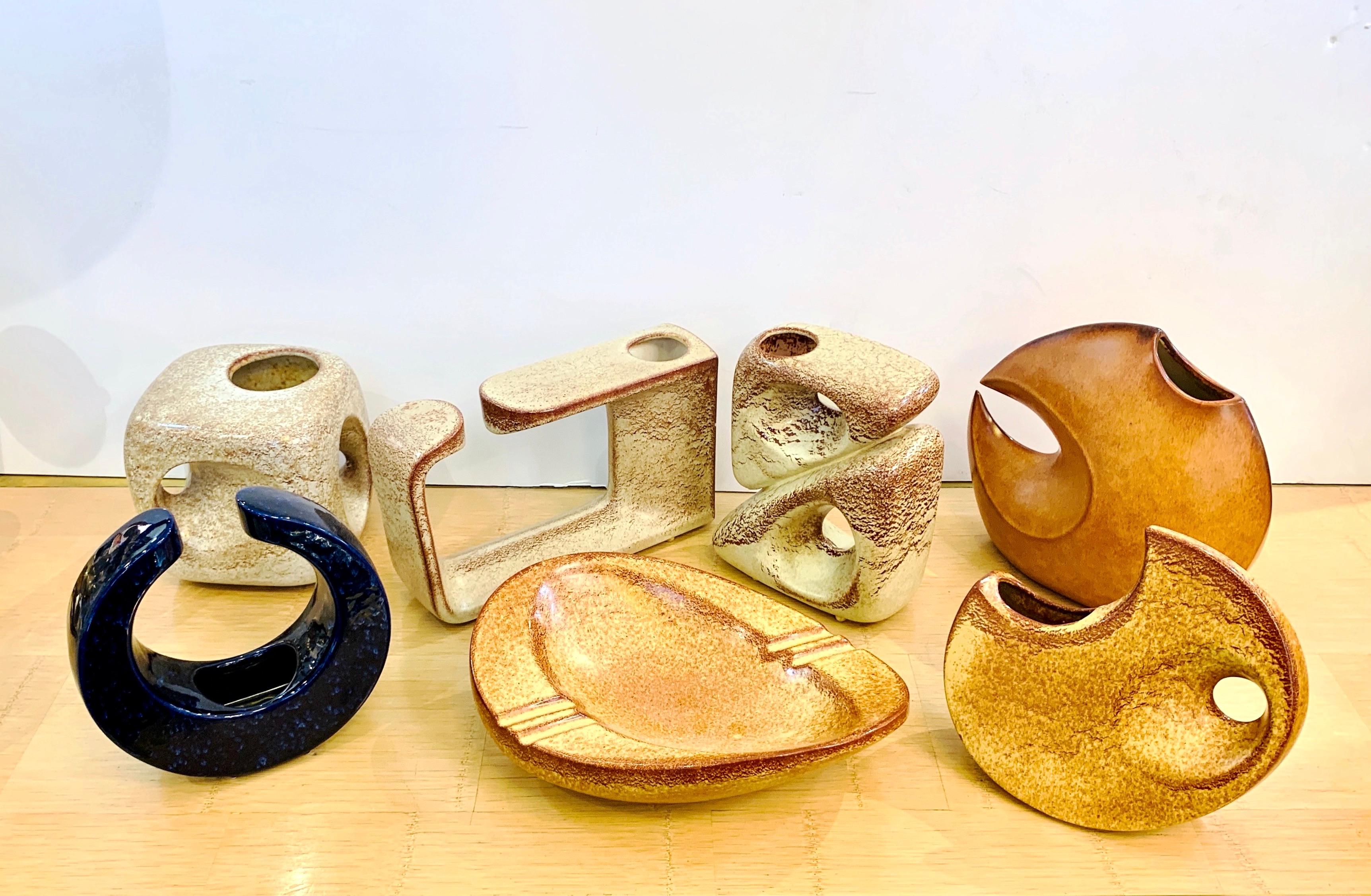 Create a sculptural arrangement of organic shapes, combining style statement and functionality with these Italian vintage stoneware Art pieces: a group of 7 Mid-Century Modern different ceramics is available, 6 vases and a bowl/catch-all, by
