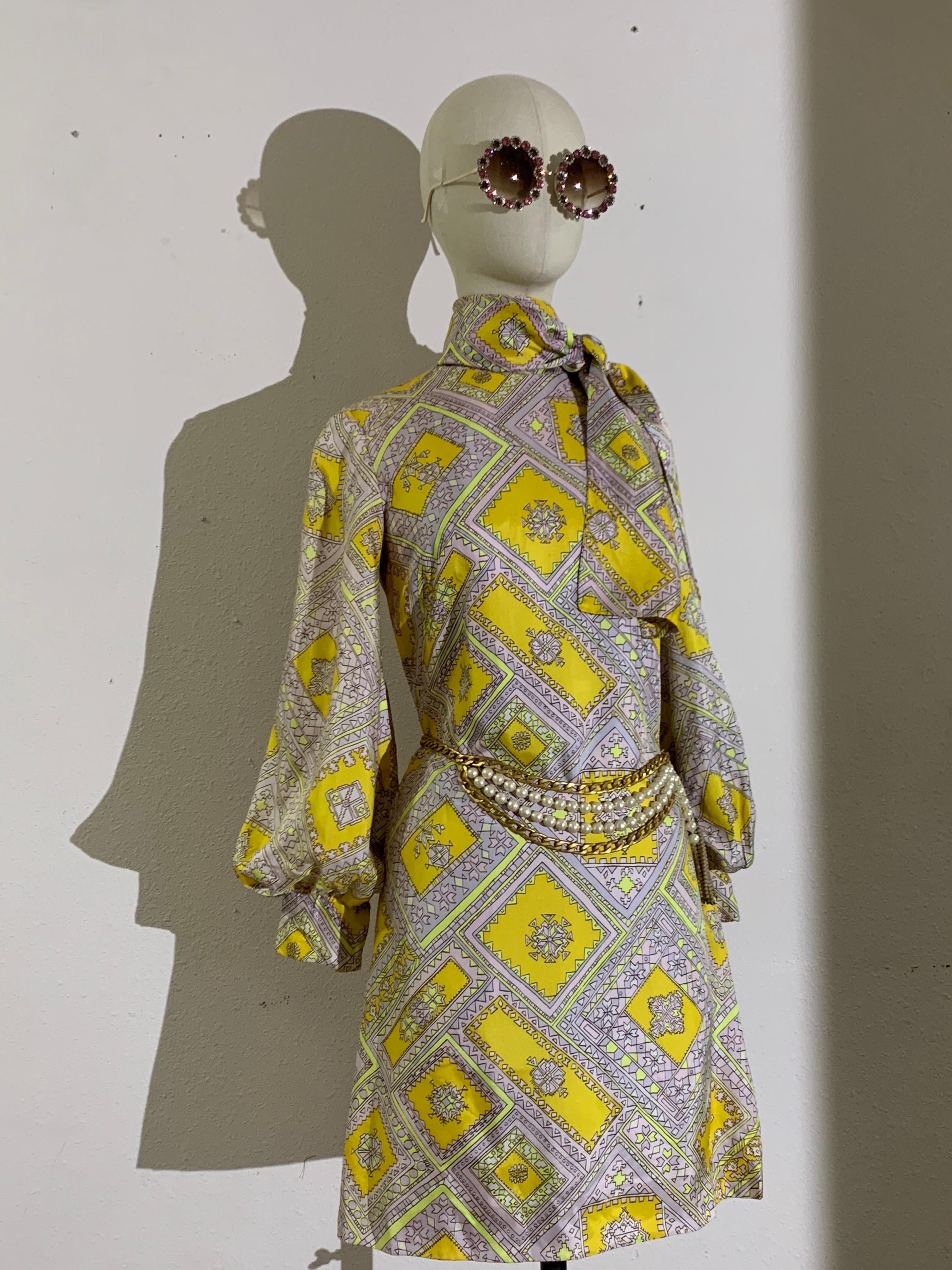 1960s Bias-Cut Satin Yellow & Lavender Tiled Psychedelic Medallion Print A-Line Dress w Bow at Neckline: Union-made. Lined with balloon sleeves, fitted wide cuffs and large foulard attched at neckline. Zip at back. Special feature--Glows in the dark