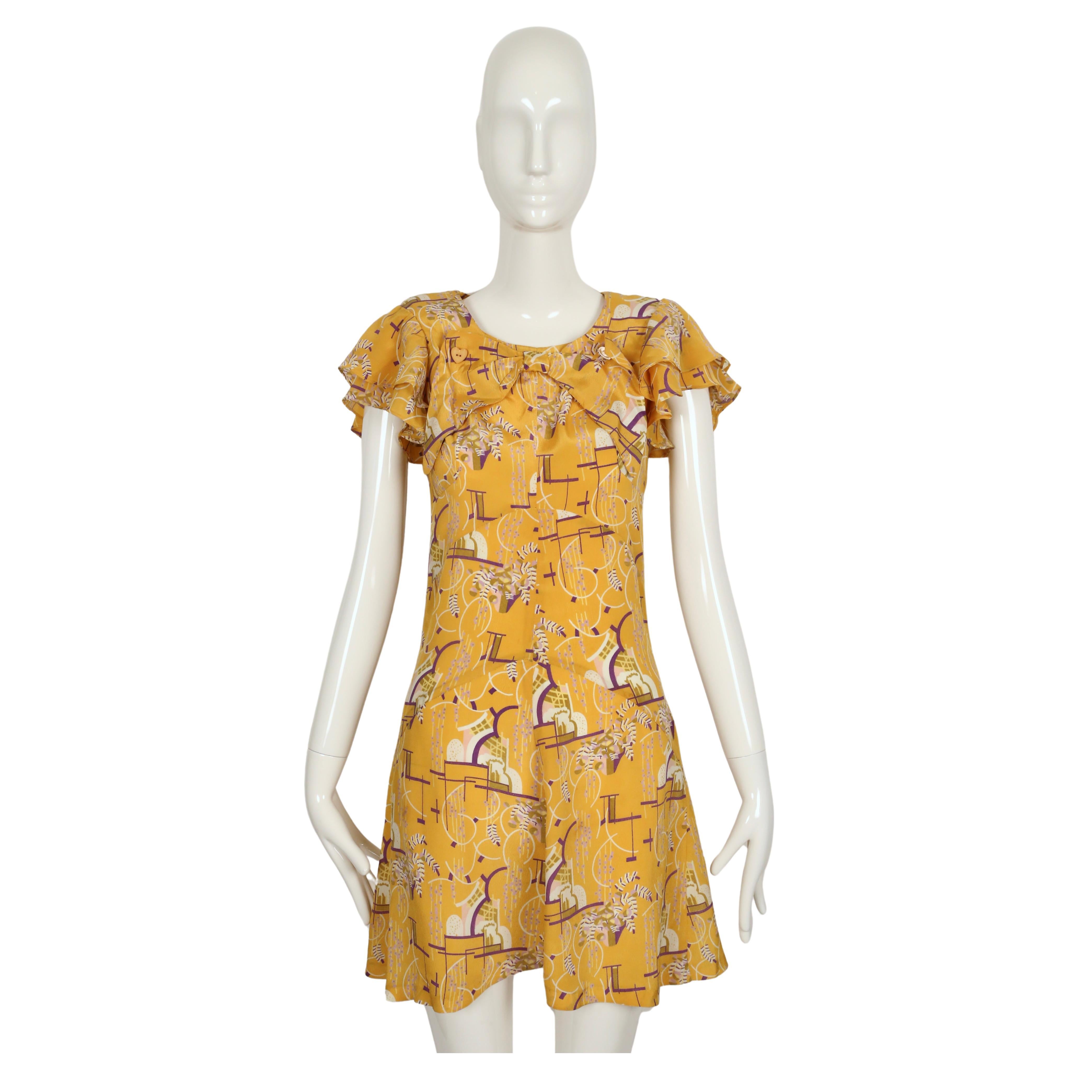 Very rare, art deco printed jacquard mini dress with flounced collar, padded shoulders and heart buttons designed by Barbara Hulanicki for Biba dating to the 1960's. The size label is no longer present although this best fits a US 2 or 4.