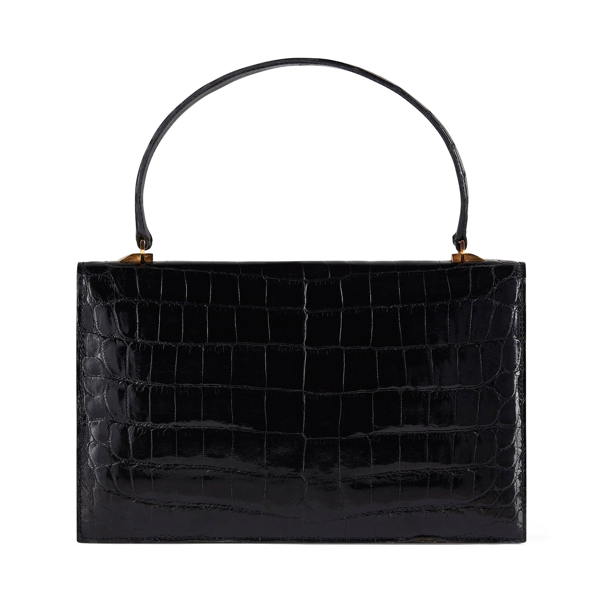 This crocodile leather bag was retailed by British luxury accessories label Asprey in the 1960s and was possibly made by  the leather goods firm and luxury House, Gucci.  We have seen an identical bag bearing the House's stamp from the same period.