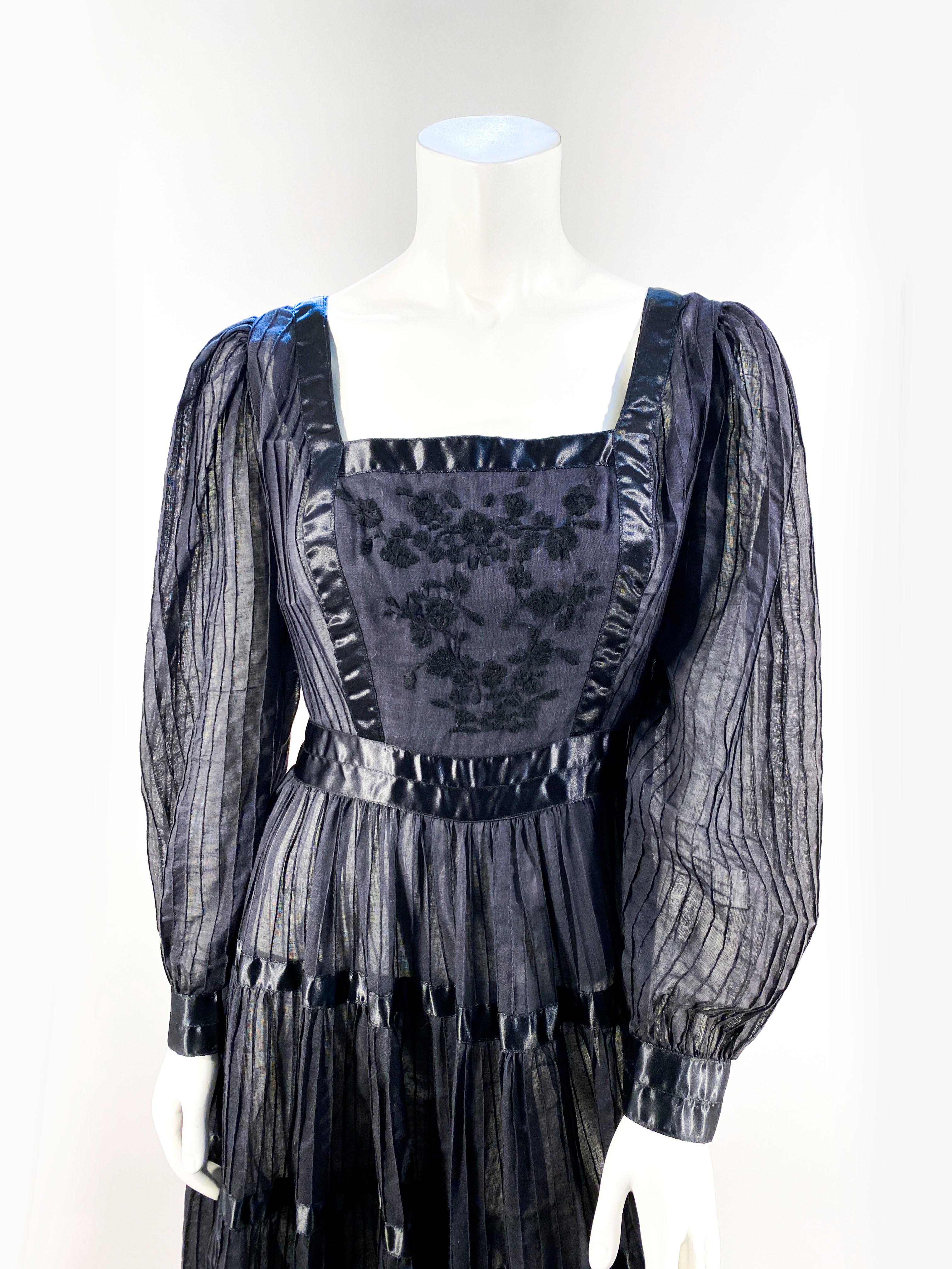 1960s Peasant/Bohemian Dress with a sheer pin pleated black cotton with satin striping, an embroidered torso, full circle skirt, and cuffed sleeves. 