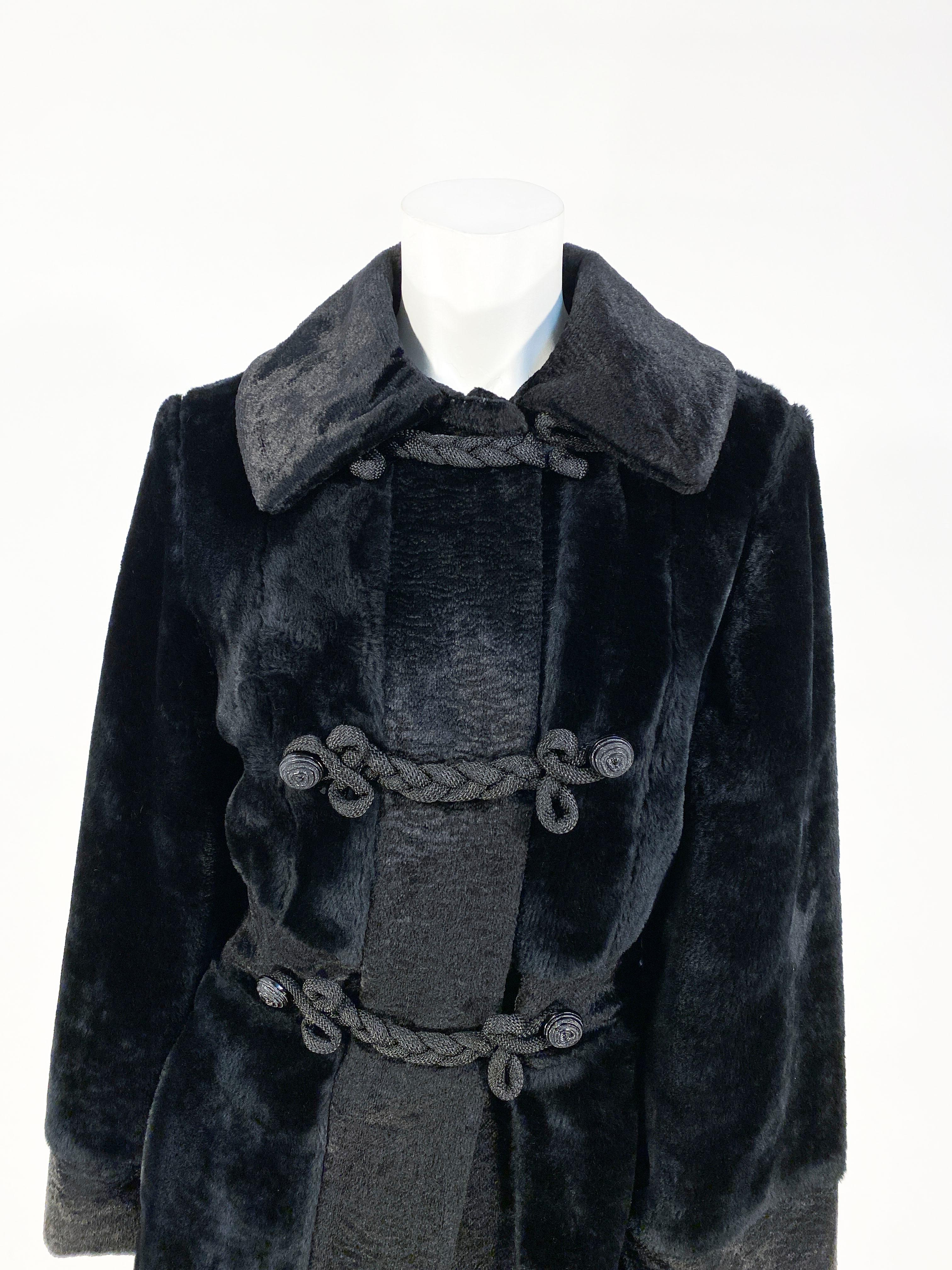 1960s Black faux fur/plush velvet mod coat with a Russian-influence. The coat is mid-length with hand made woven cordé elongated frog closures along the double-breasted face of the coat. The buttons are original and the coat has front pockets. 