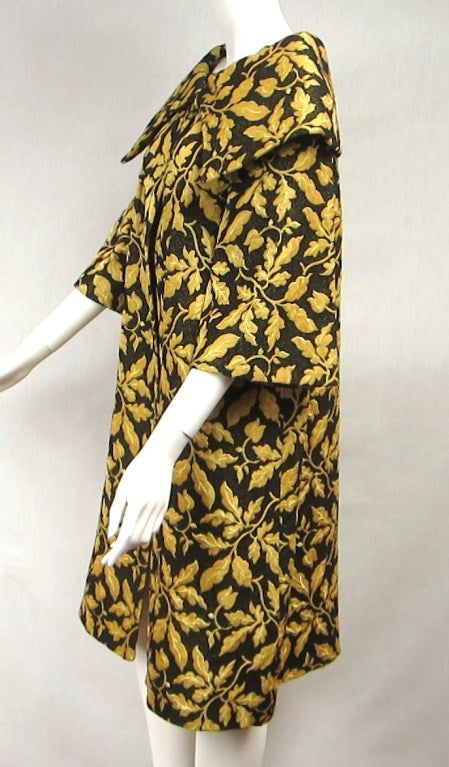 Full swing on this beauty with a Large wide collar. Bracelet sleeves with Black and gold brocade floral. Two buttons at the neck front. Wonderful Swing coat to wear over a stunning cocktail dress. Up to 40 inch  bust - Up to 42 waist- Open hips- 7.5