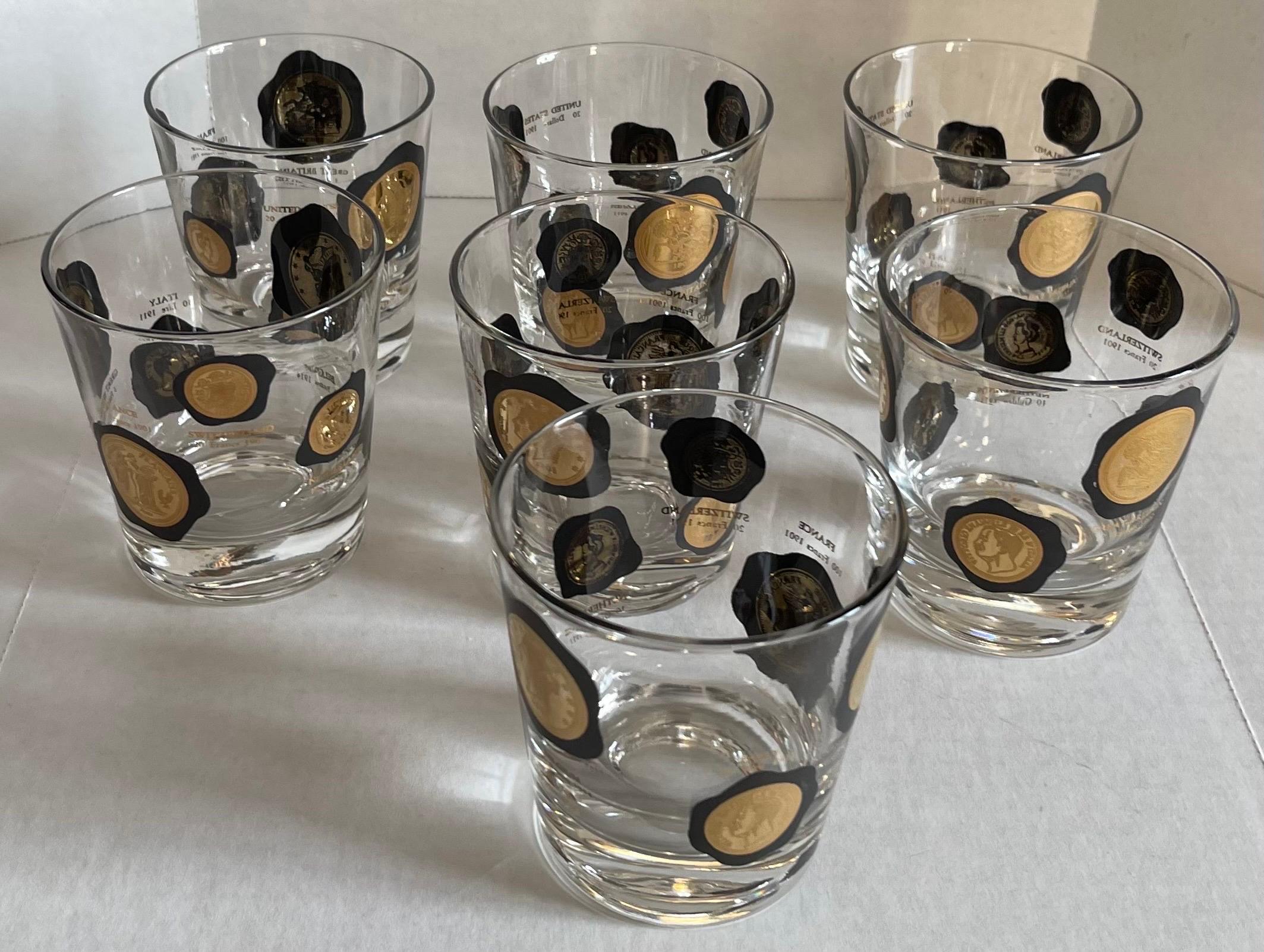 Set of 7 1960s small cocktail glasses by Cera. Clear glass with overall applied black and gold coin motif. 