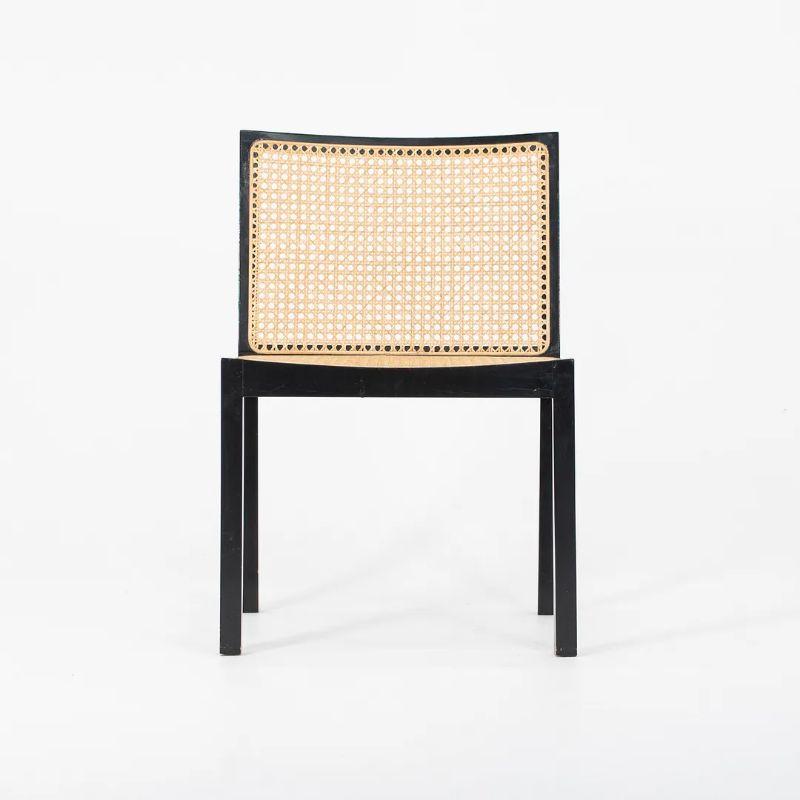 This is a set of 6 Bankstuhl caned dining chairs, designed by Willy Guhl. This simple solid model of dining chair is composed of a wood frame with a caned seat and back. 
This silhouette was designed by Guhl in 1959, and this set was manufactured