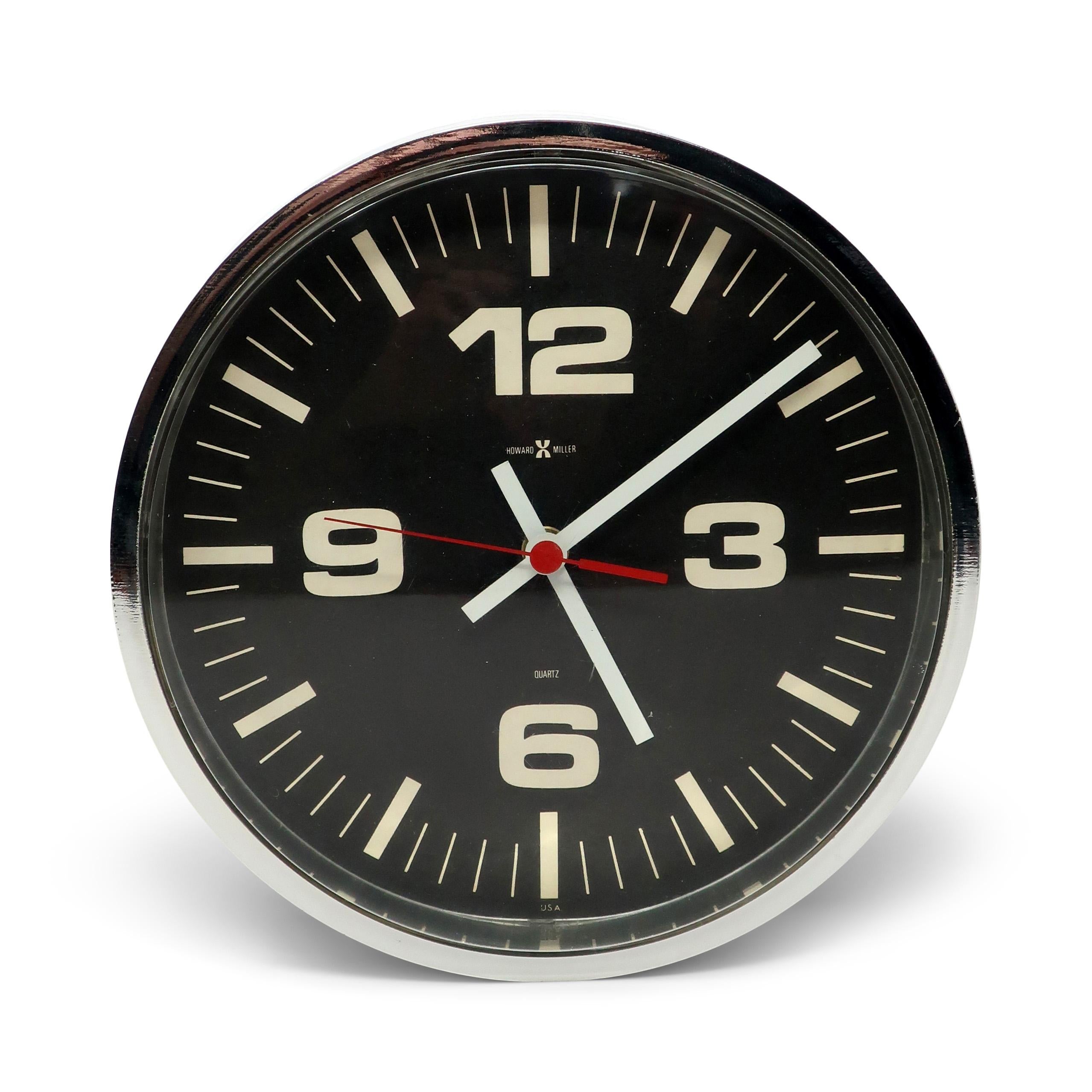 A fantastic and rare mid-century modern wall clock by American clock manufacturer Howard Miller.  Not marked but very similar to the designs Arthur Umanoff and George Nelson did for Howard Miller around the same time.  It has a plastic mirrored