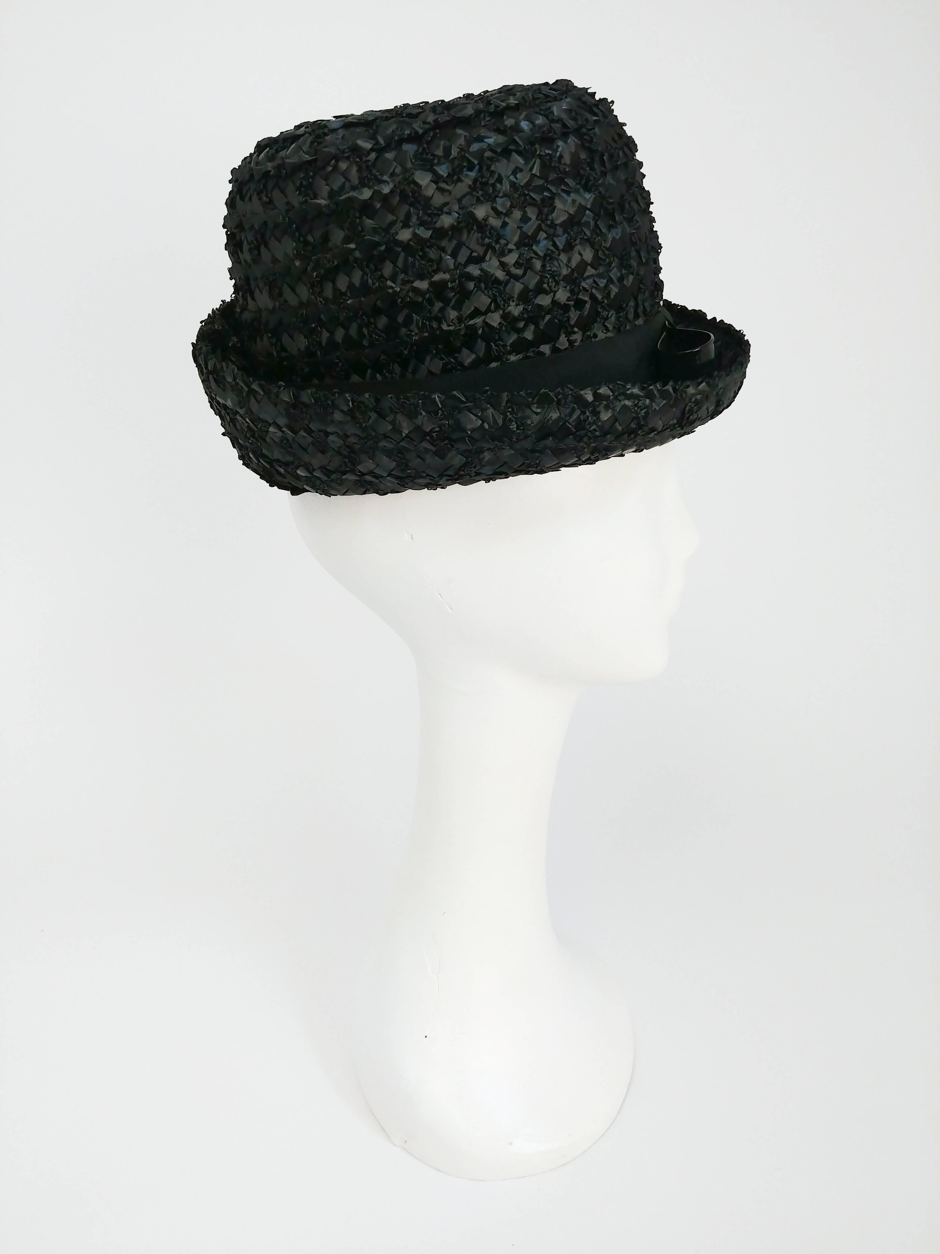 1960s Black Raffia Hat w/ Vinyl Bow. Black rounded Raffia Hat with a black vinyl band and bow. 20.5 inch circumference.