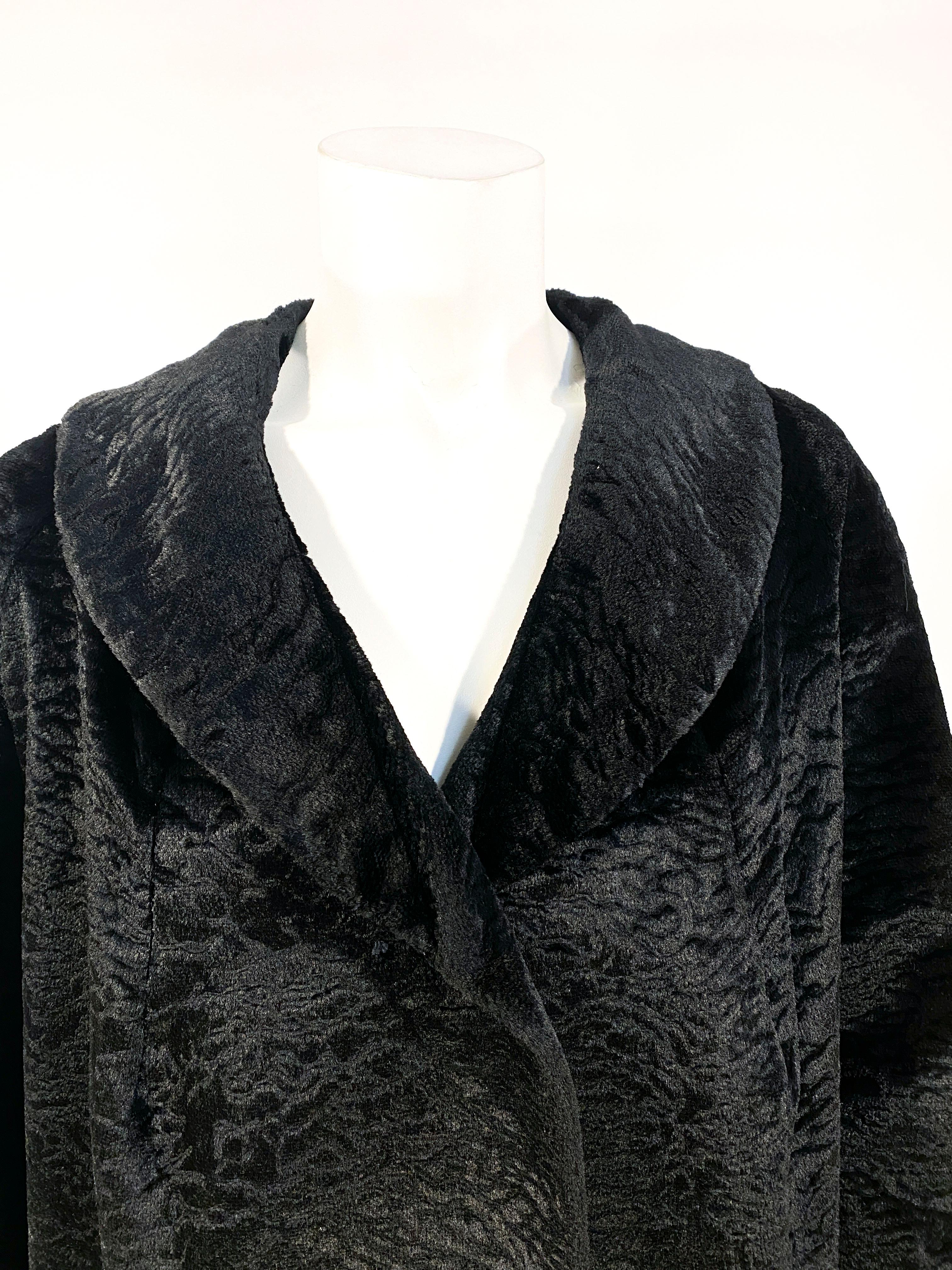 1960s black sculpted velour jacket with faux decorative pockets, slightly full sleeves, modest shawl collar and black jeweled buttons. 
