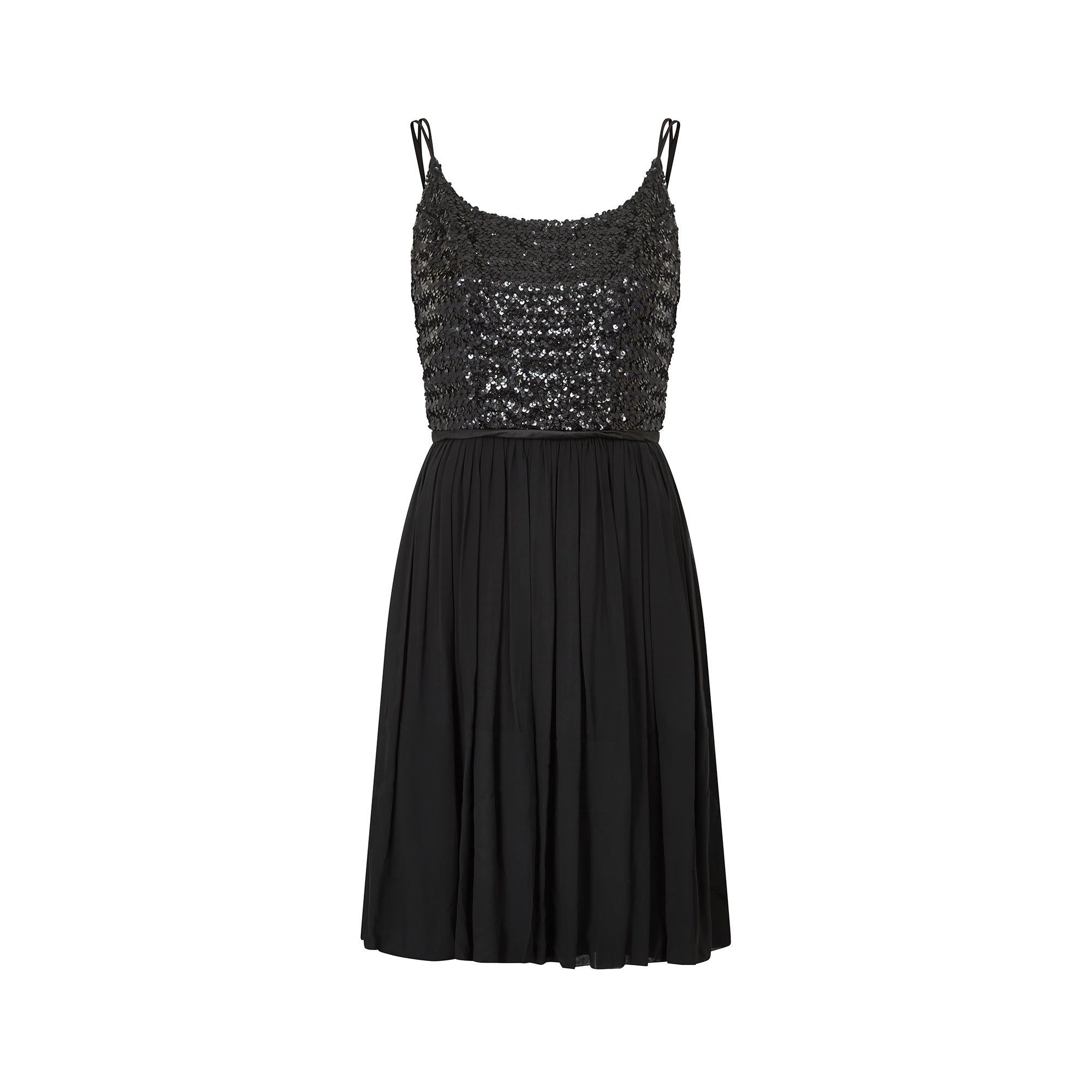 Original 1960s black sequinned dress which would make the perfect occasion dress. It features a heavily sequinned bodice with a double satin spaghetti strap and curved chest seams to create shape and support the bust. The dress fastens at the rear