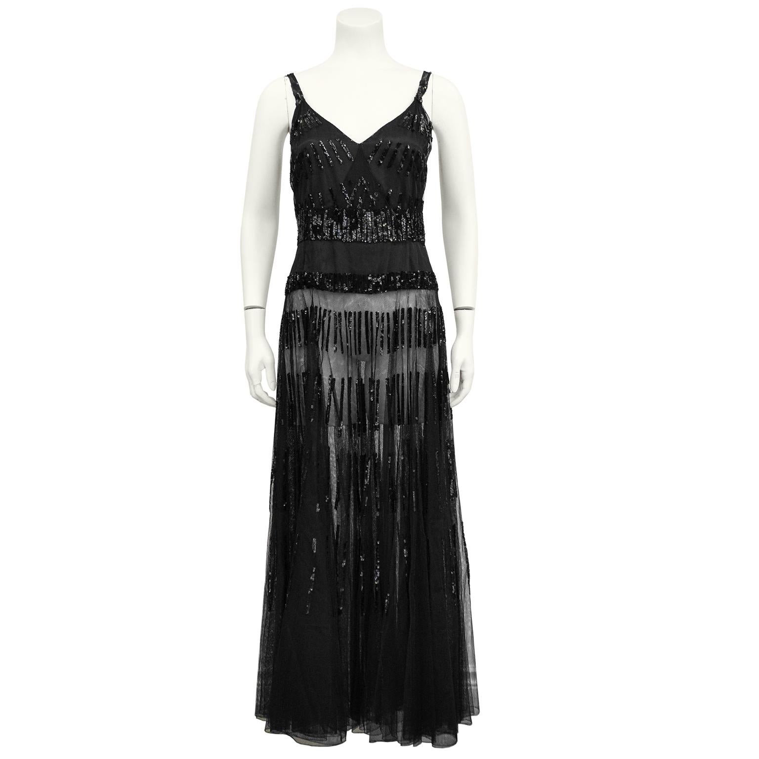 Stunning black sheer and beaded gown and bolero. Reminiscent of the slinky beaded and net gowns from the 1940's. Spaghetti straps with a v-neck line and a faux wrap style bodice. Small jet black sequin embellish the straps and bodice with small
