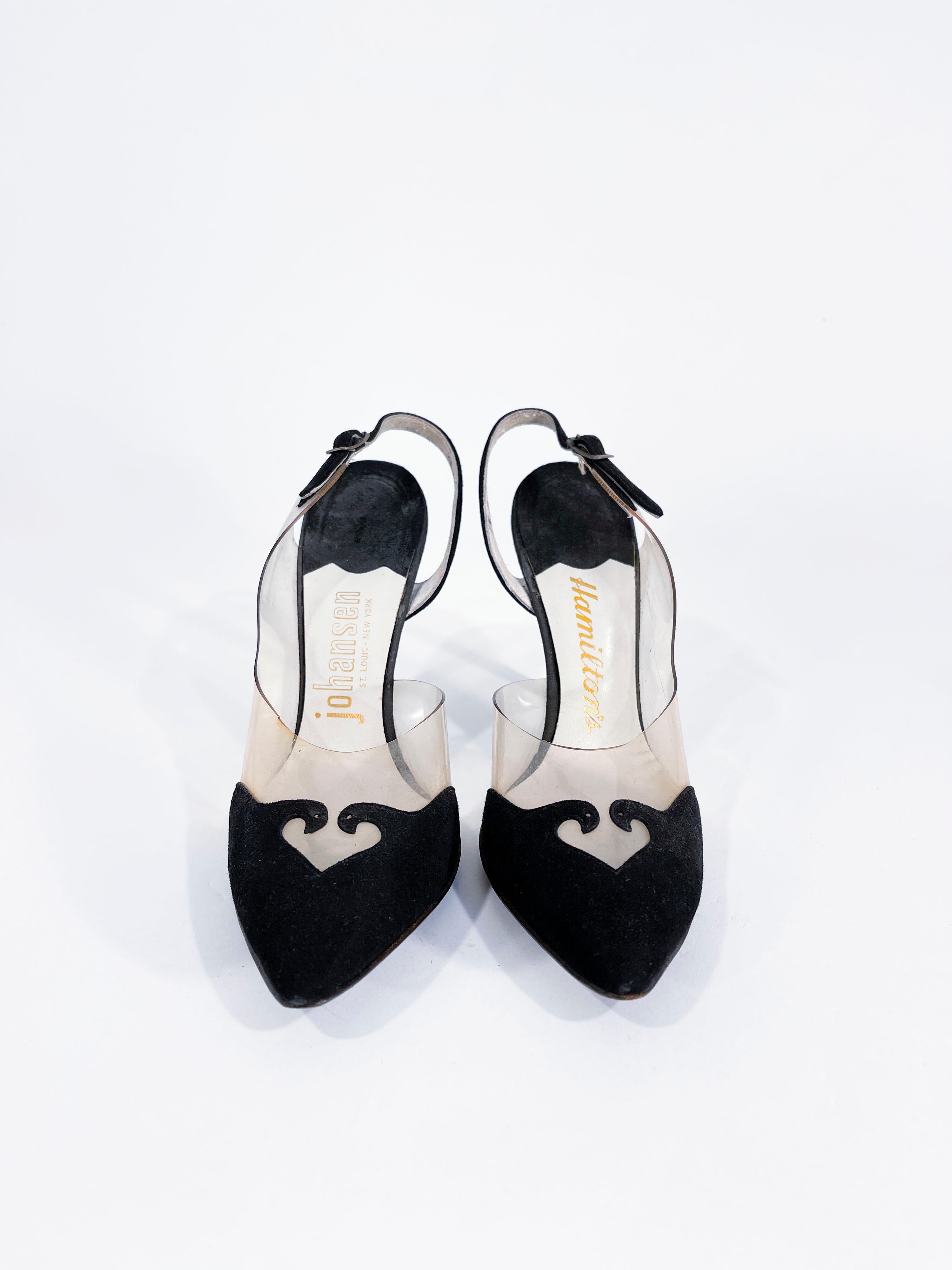 1960s black suede and clear vinyl stiletto heels featuring a decorative contrasting pattern, slightly back open heel and a pointed toe. The heel is 3.5 inches tall.