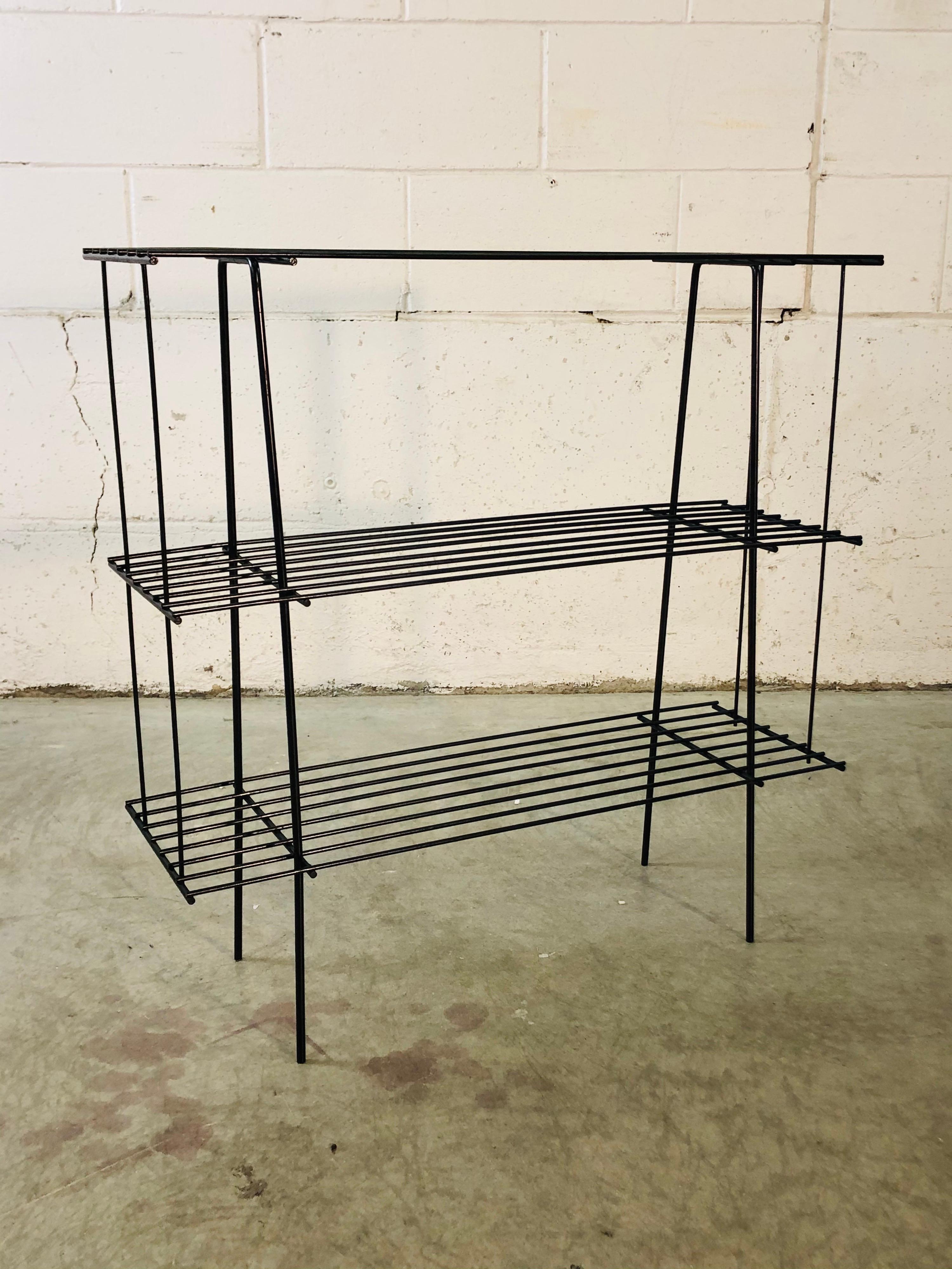 Vintage 1960s black metal wire rack boom shelf with two shelves for storage. Excellent refinished condition. No marks.